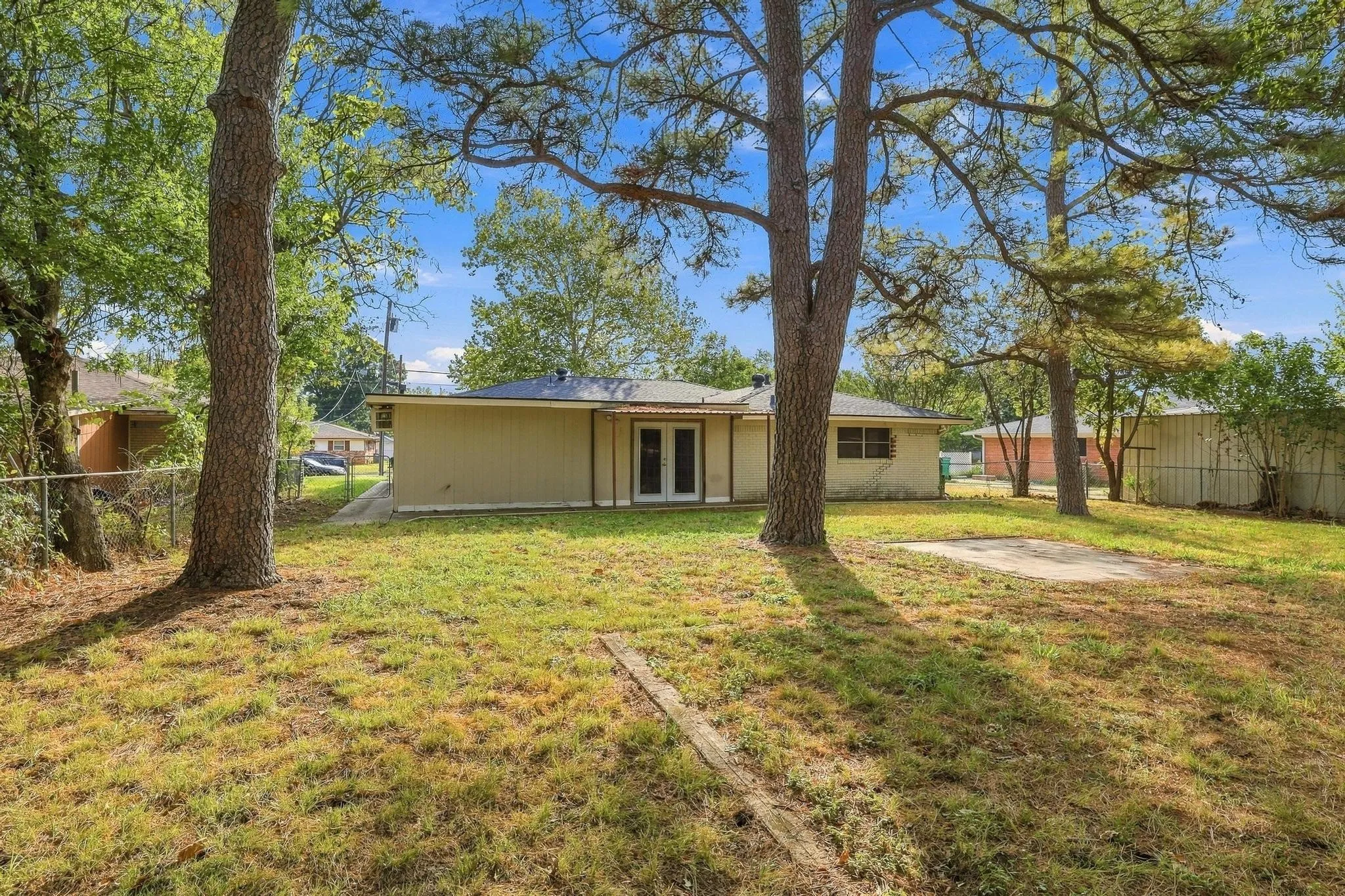 Large fenced backyard with plenty trees