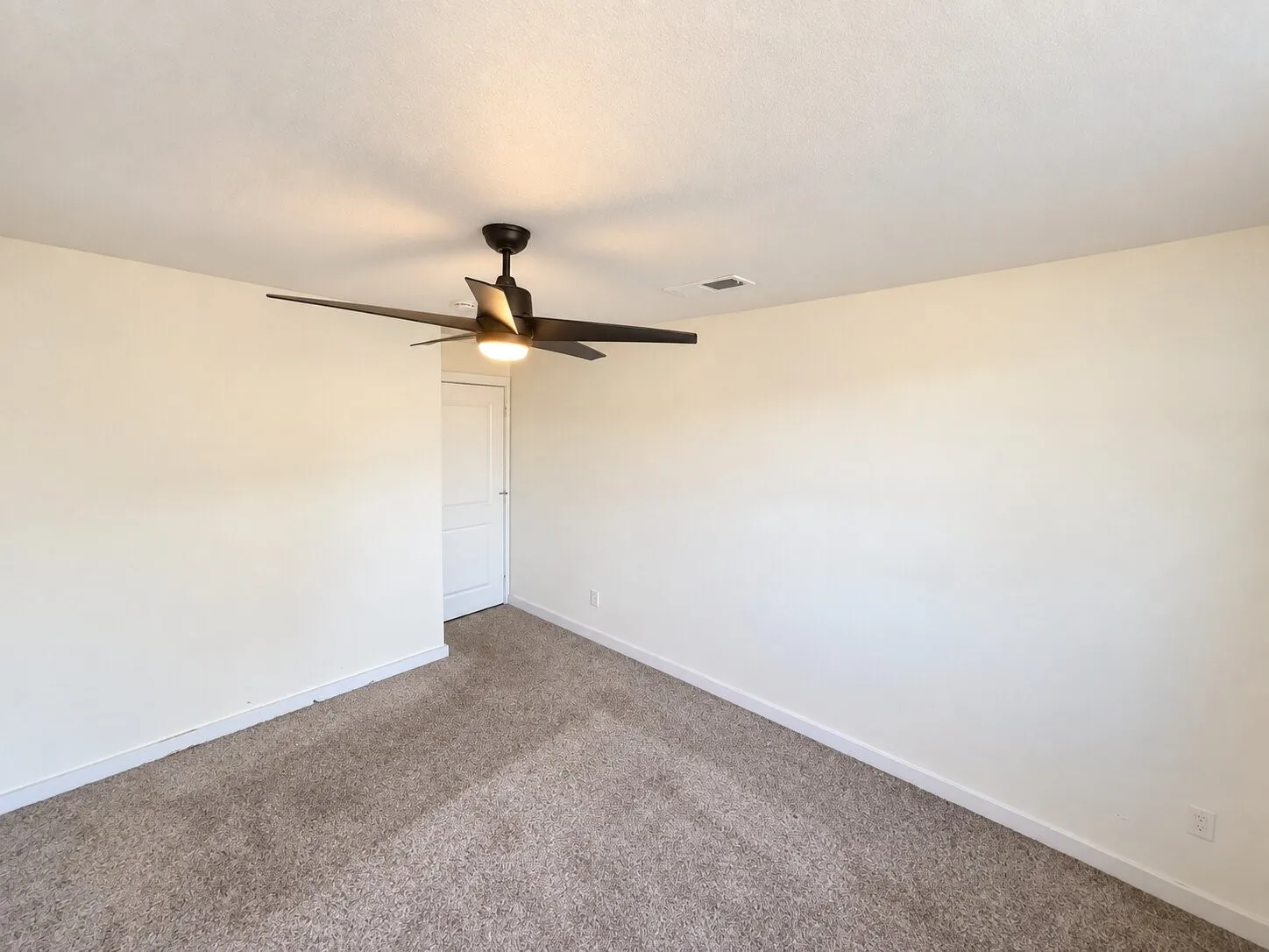 Wall-to-wall carpeting with a modern ceiling fan and recessed lighting