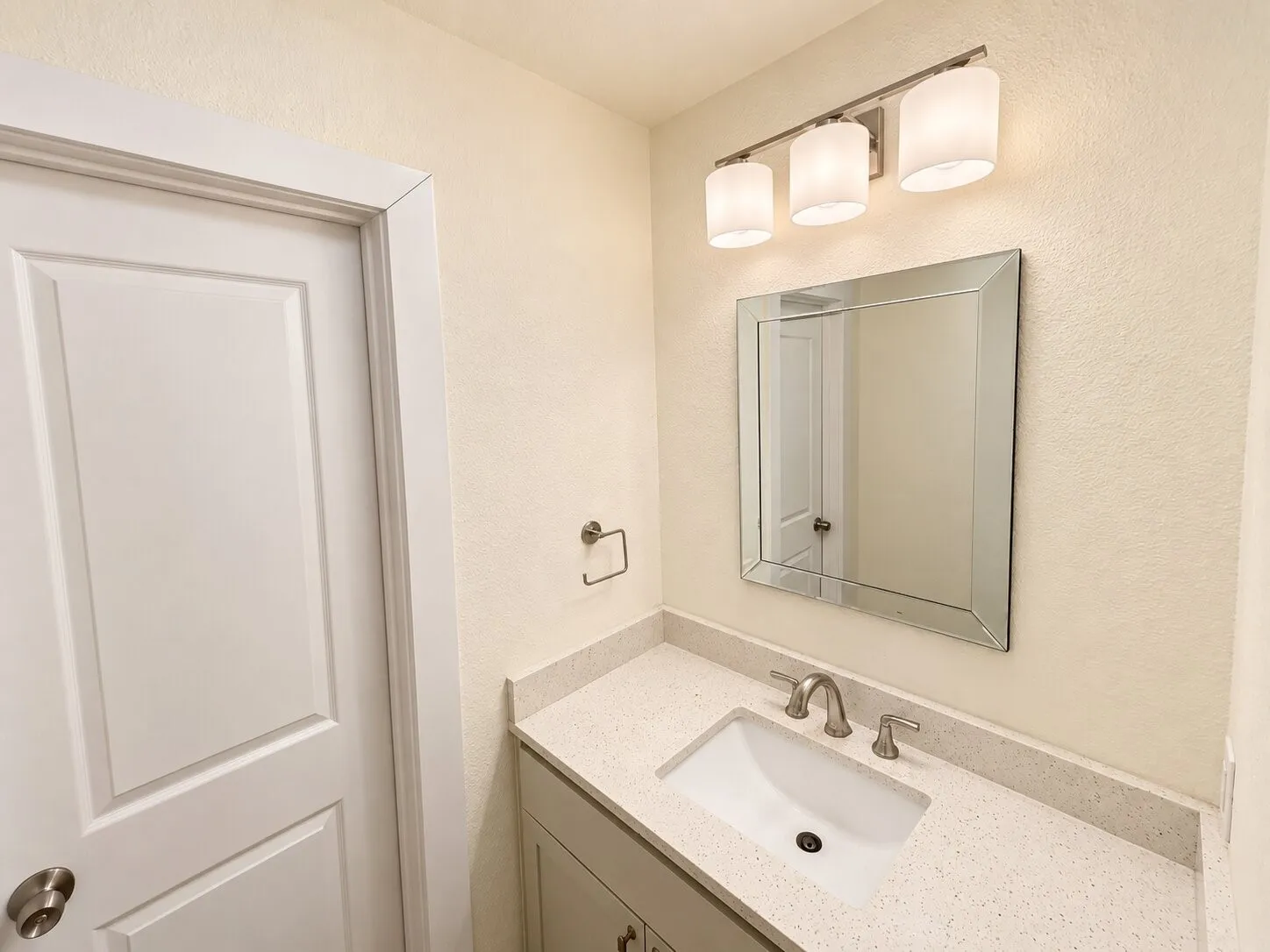 Vanity featuring a single undermount sink, brushed nickel faucet, and a light-toned countertop