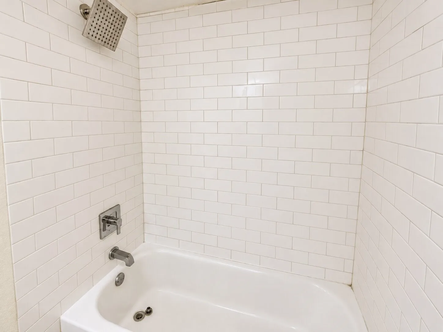 White subway tile surround with a built-in tub and shower
