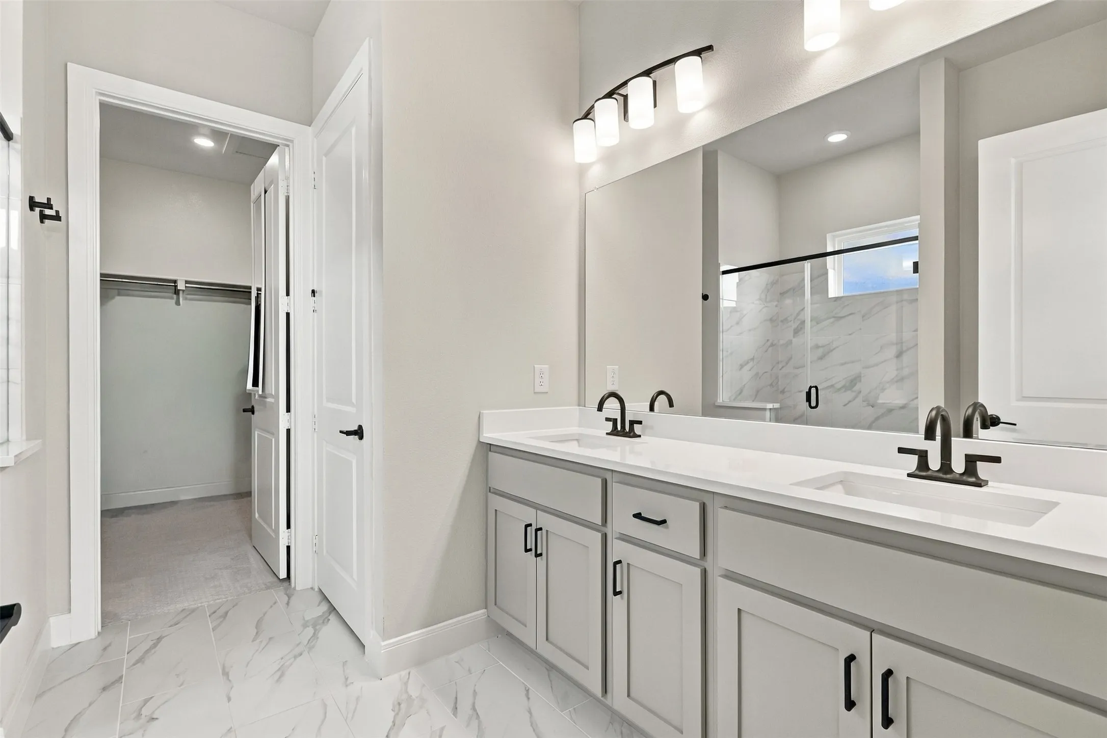 Double vanity with undermount sinks, quartz countertops, and matte black fixtures