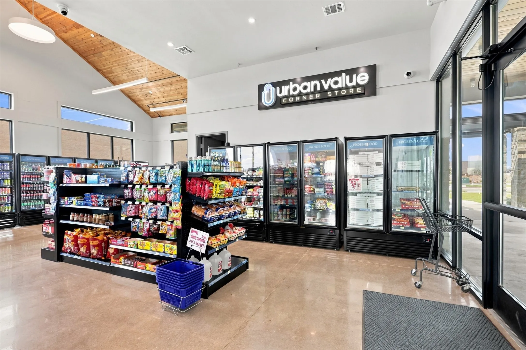 Polished concrete flooring, high vaulted wood-finish ceiling, large display refrigeration units, extensive shelving, and prominent brand signage