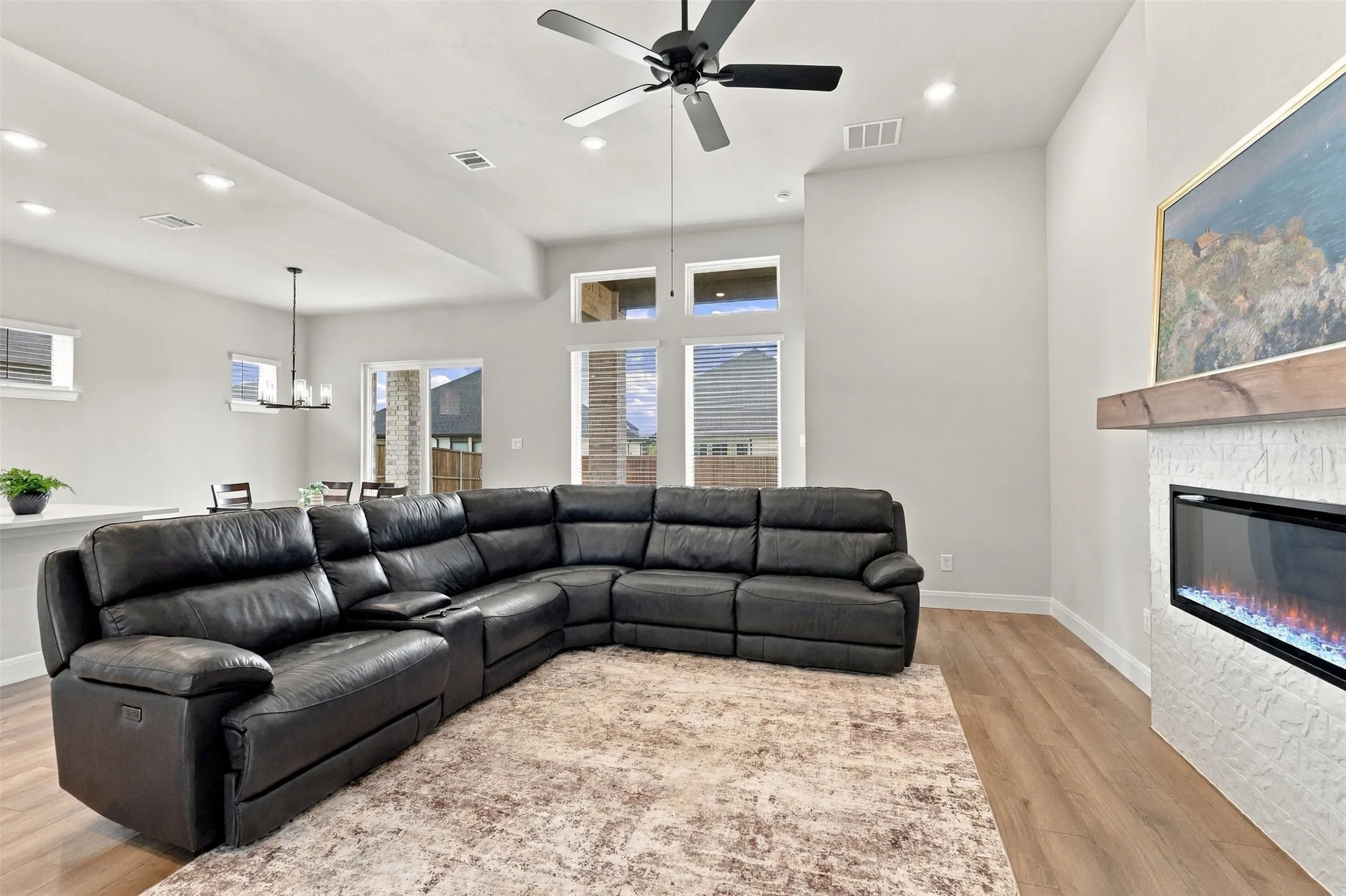 Wood-finish flooring, recessed lighting, and a ceiling fan