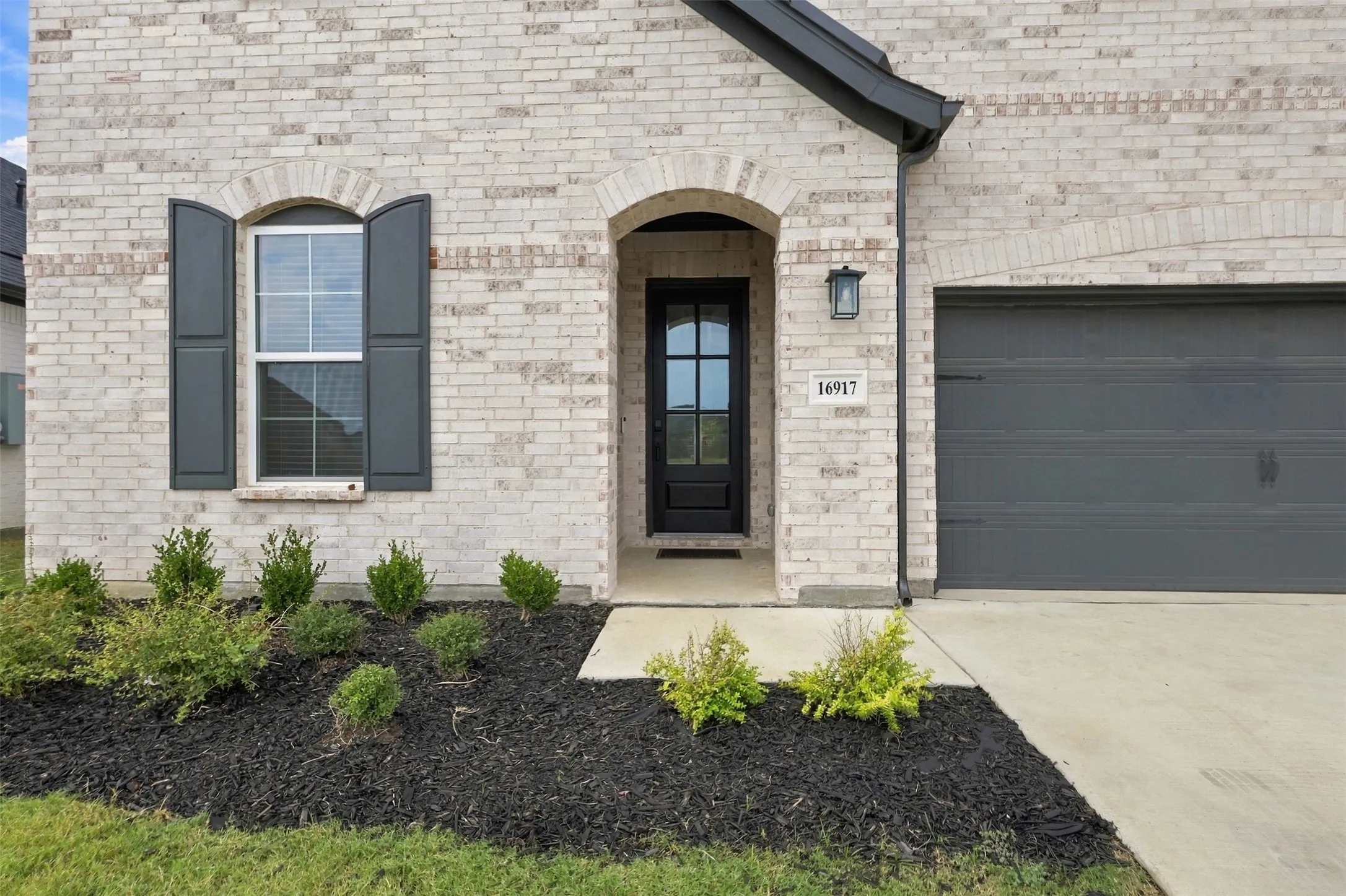Light-colored brick exterior with dark gray accents