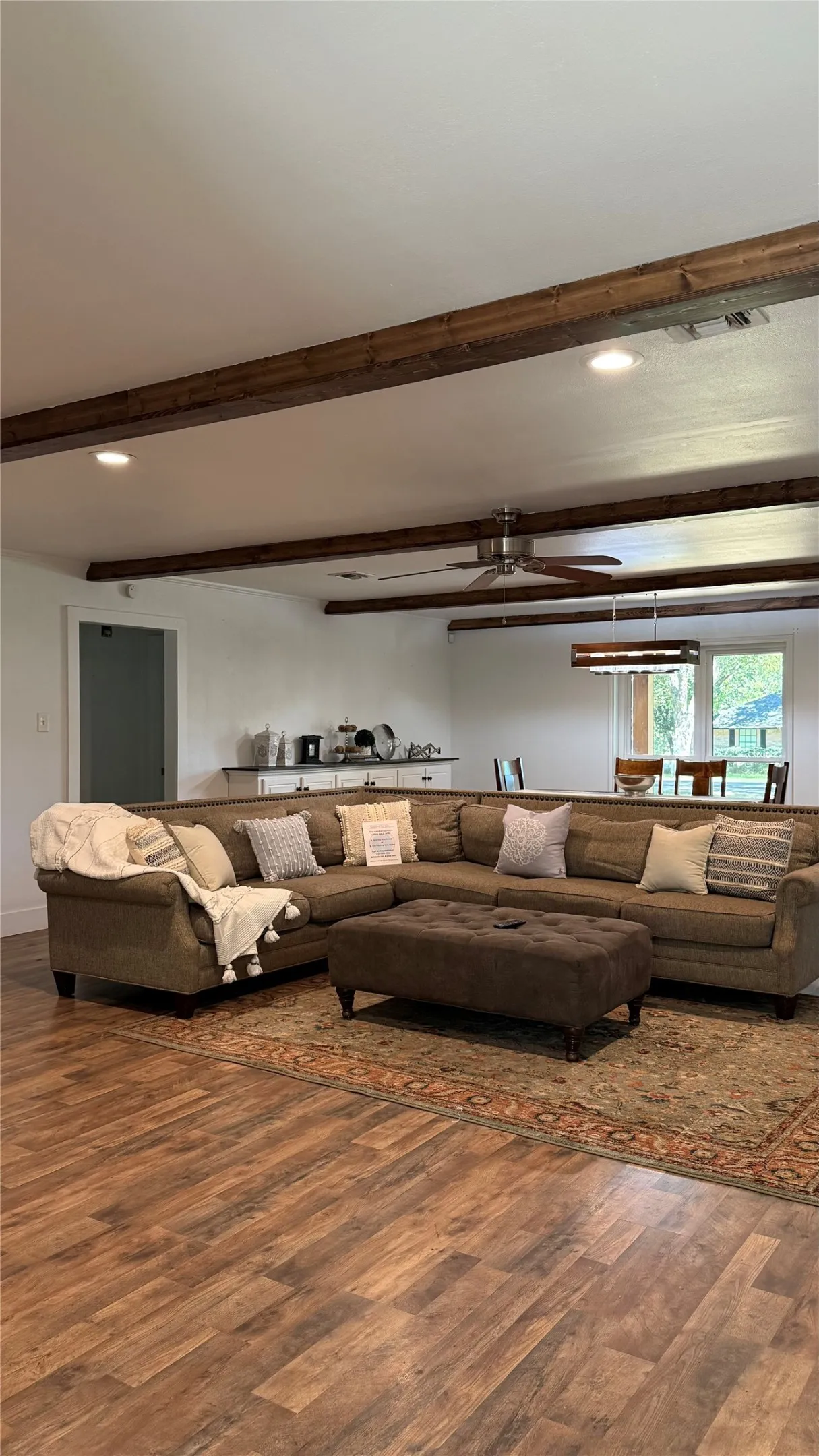 Wood-finish flooring throughout, complemented by exposed ceiling beams
