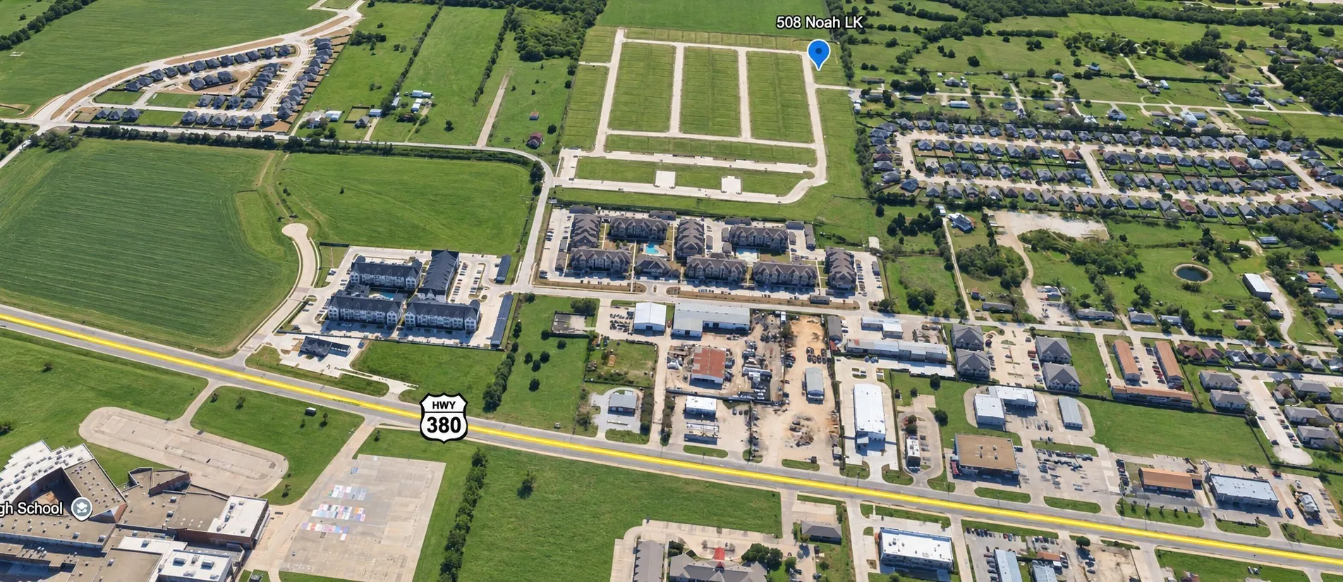Aerial perspective showcasing developed residential areas, commercial properties, and agricultural land
