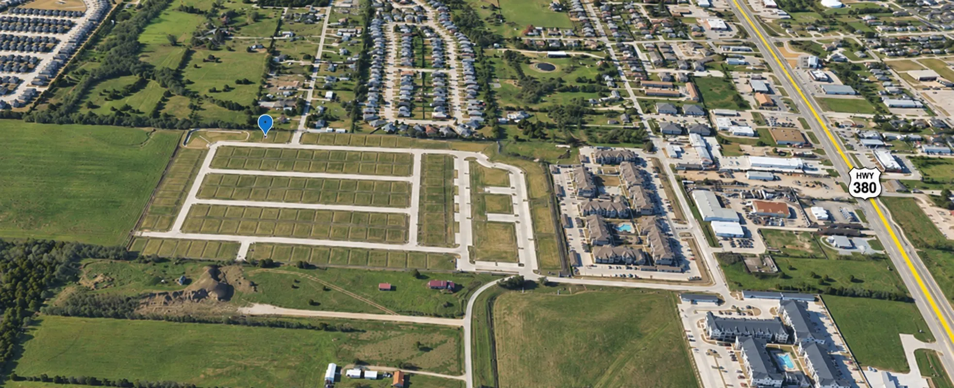Aerial perspective showcasing developed and undeveloped land parcels