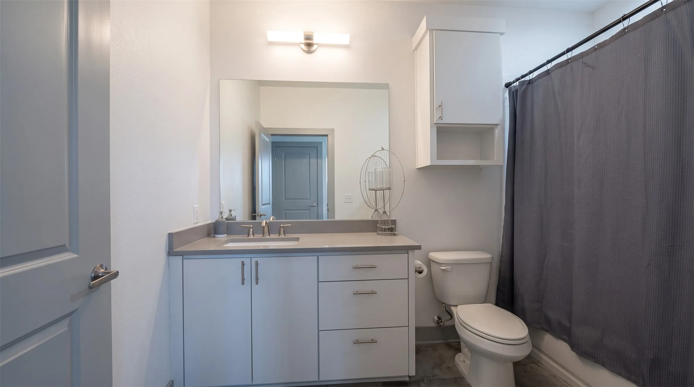 Vanity with an integrated sink, polished chrome faucet, and ample storage cabinetry