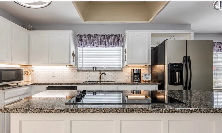 Large island adds cabinet and counter space and designer cook space