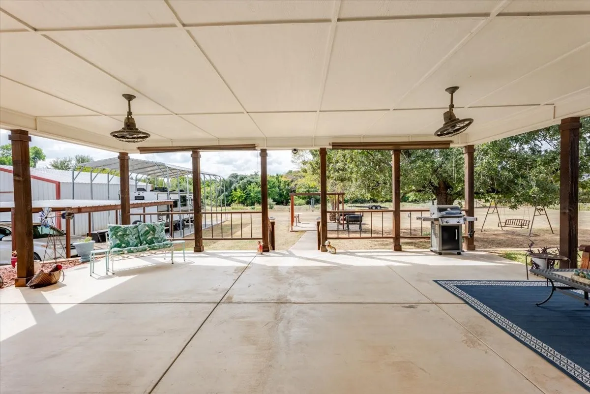 Host gatherings or game night on this amazing covered back patio with fans and outdoor blinds