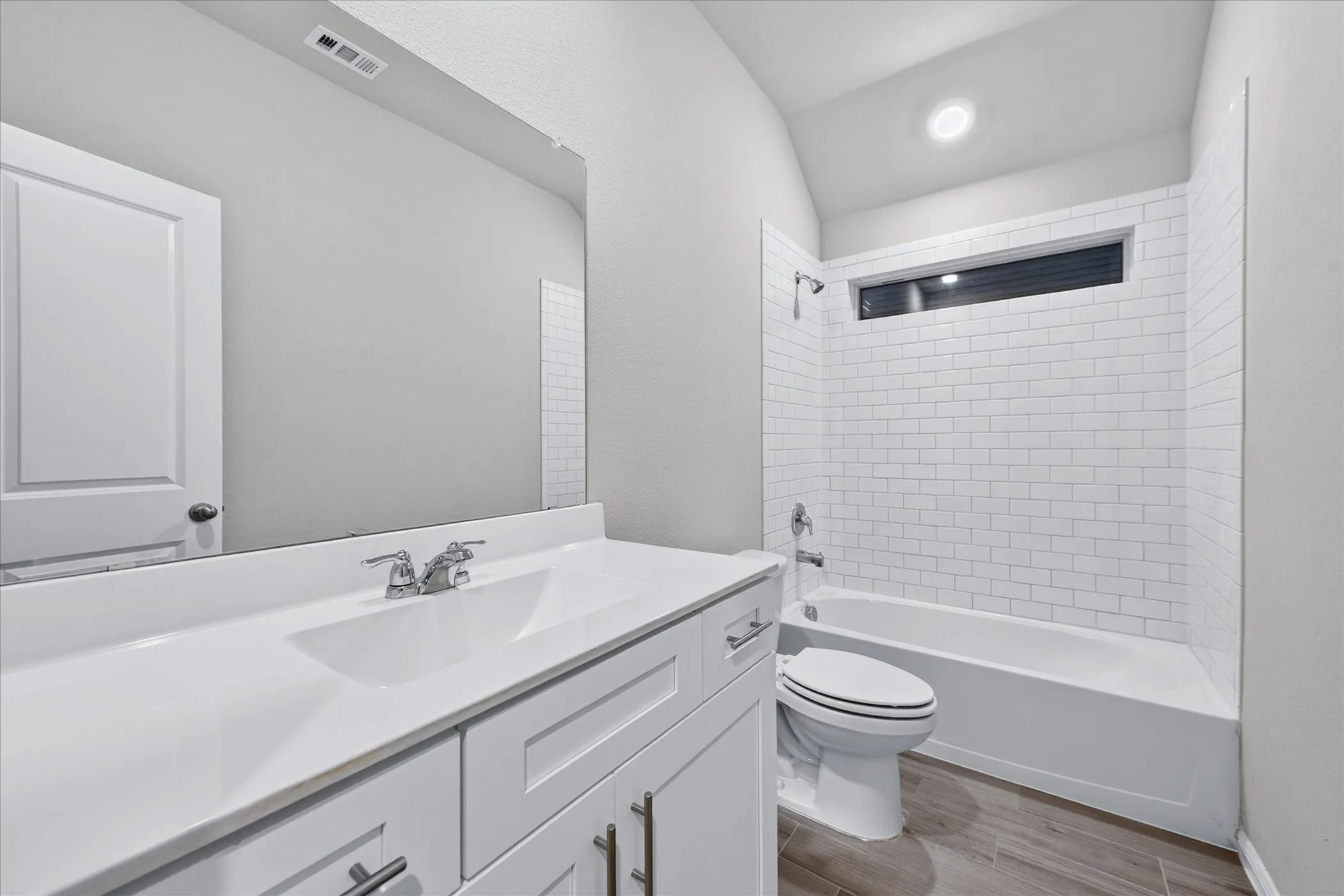 White vanity with an integrated sink and chrome faucet