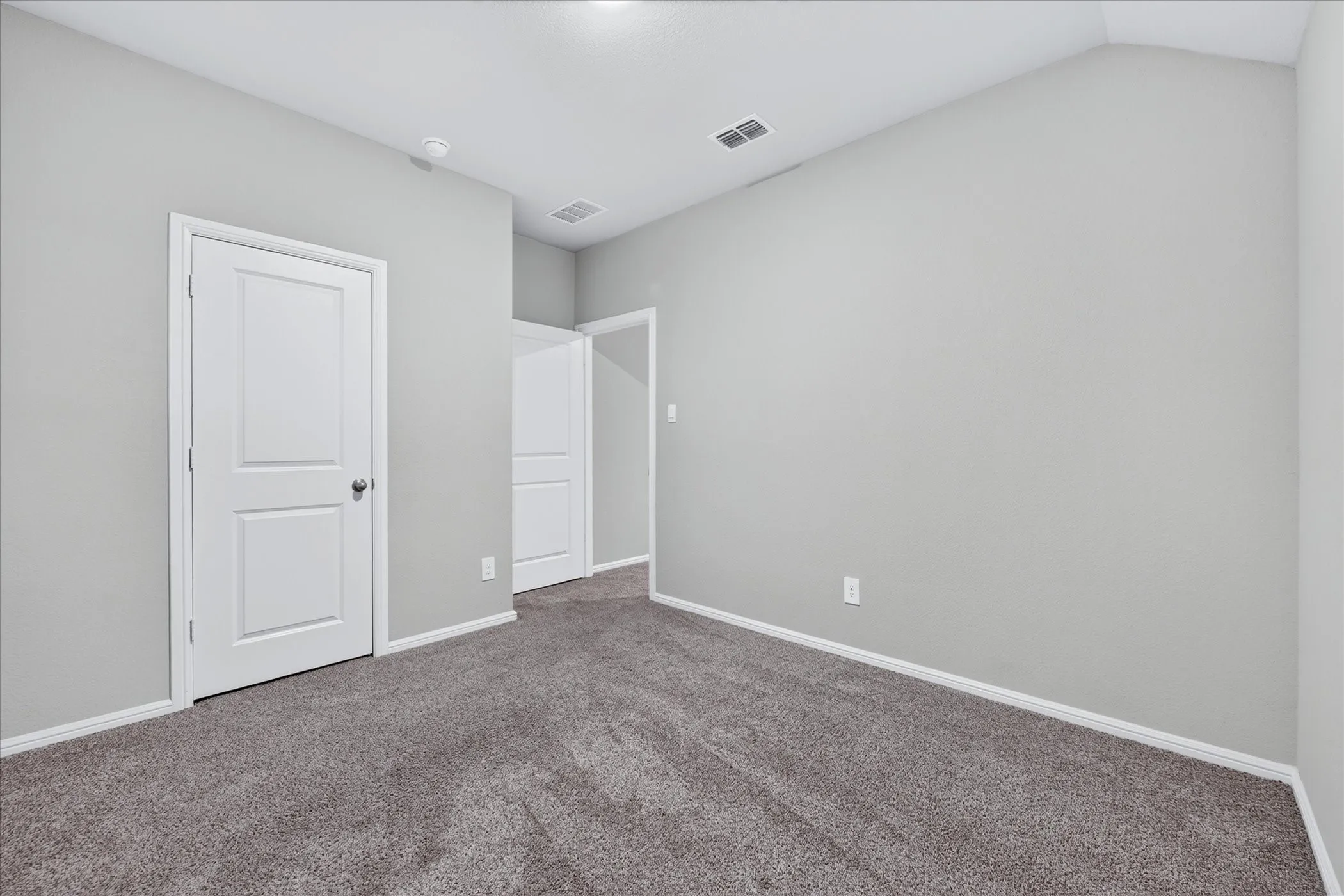 Vaulted ceiling, recessed lighting, and gray carpet flooring