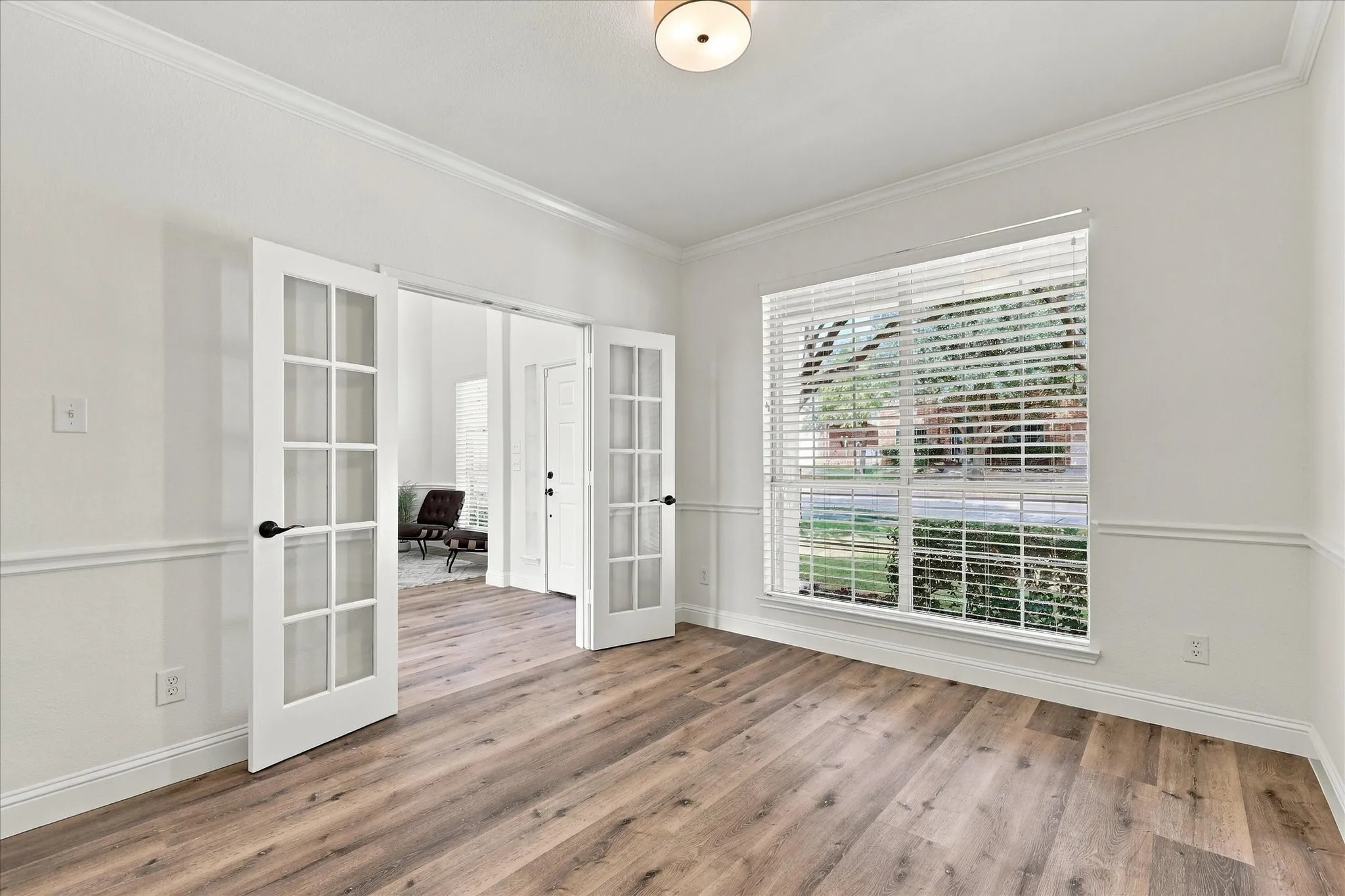 The light filled office boasts a French Door entry.