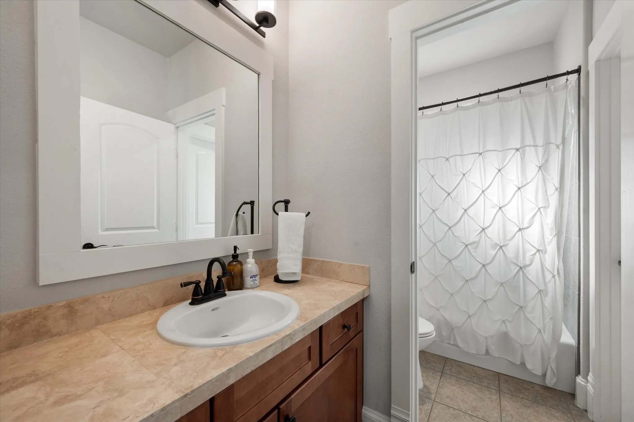 Vanity with a neutral-toned countertop and an undermount sink