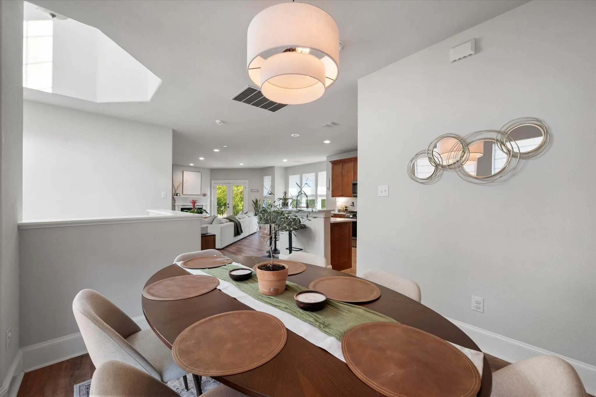 Dining area featuring a contemporary drum pendant light fixture and wood-finish flooring