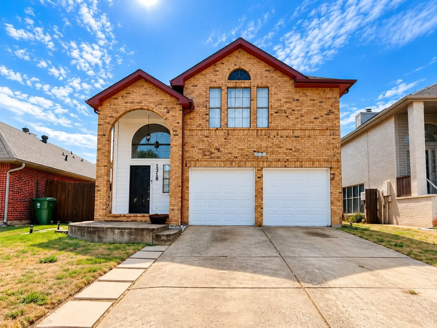 Brick exterior featuring arched entryway