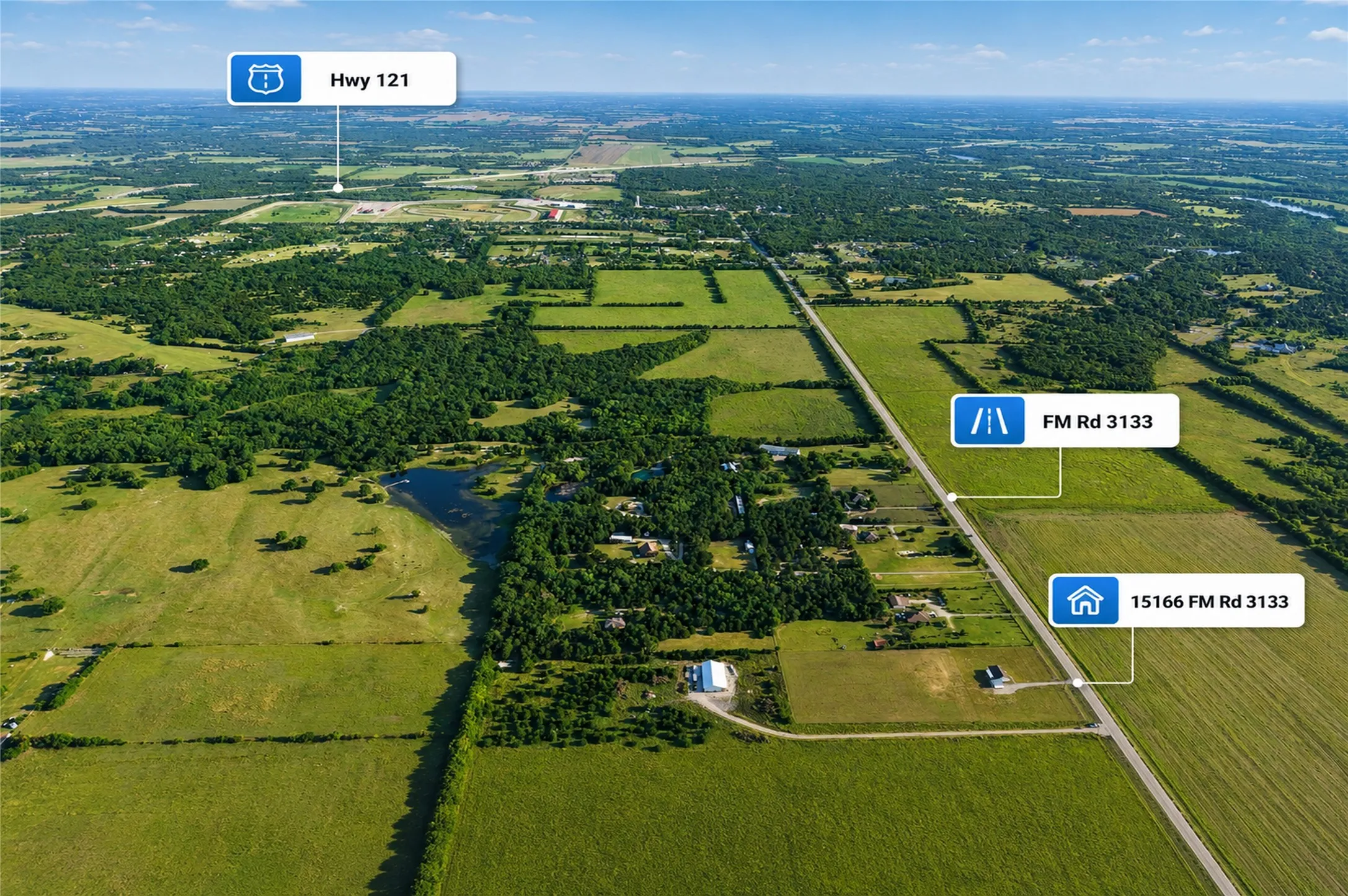 Expansive rural landscape featuring a prominent roadway (FM Rd 3133) and diverse green spaces