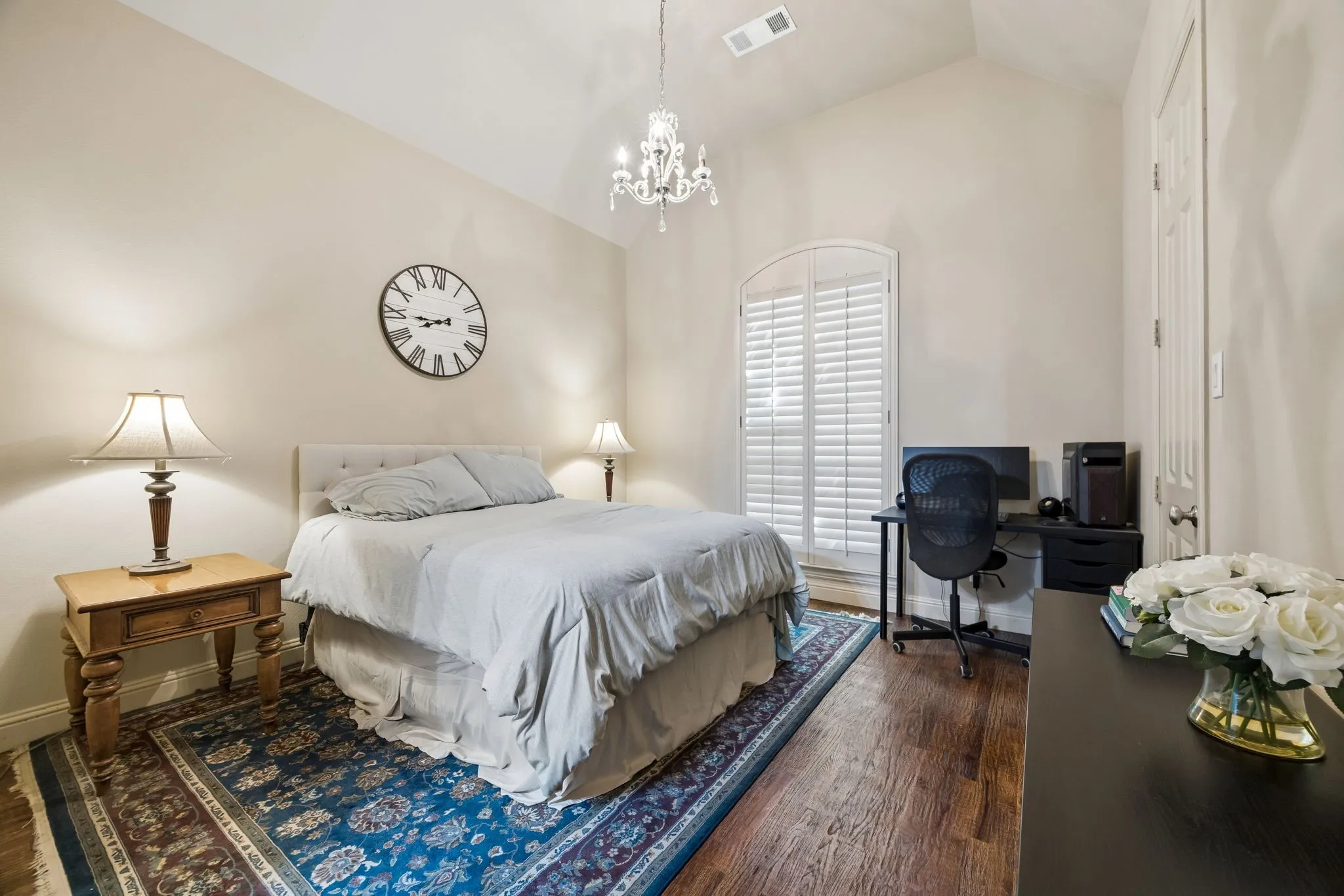 1st floor bedroom with ensuite full bath, high ceiling swith chandelier lighting, arched window with plantation shutters.