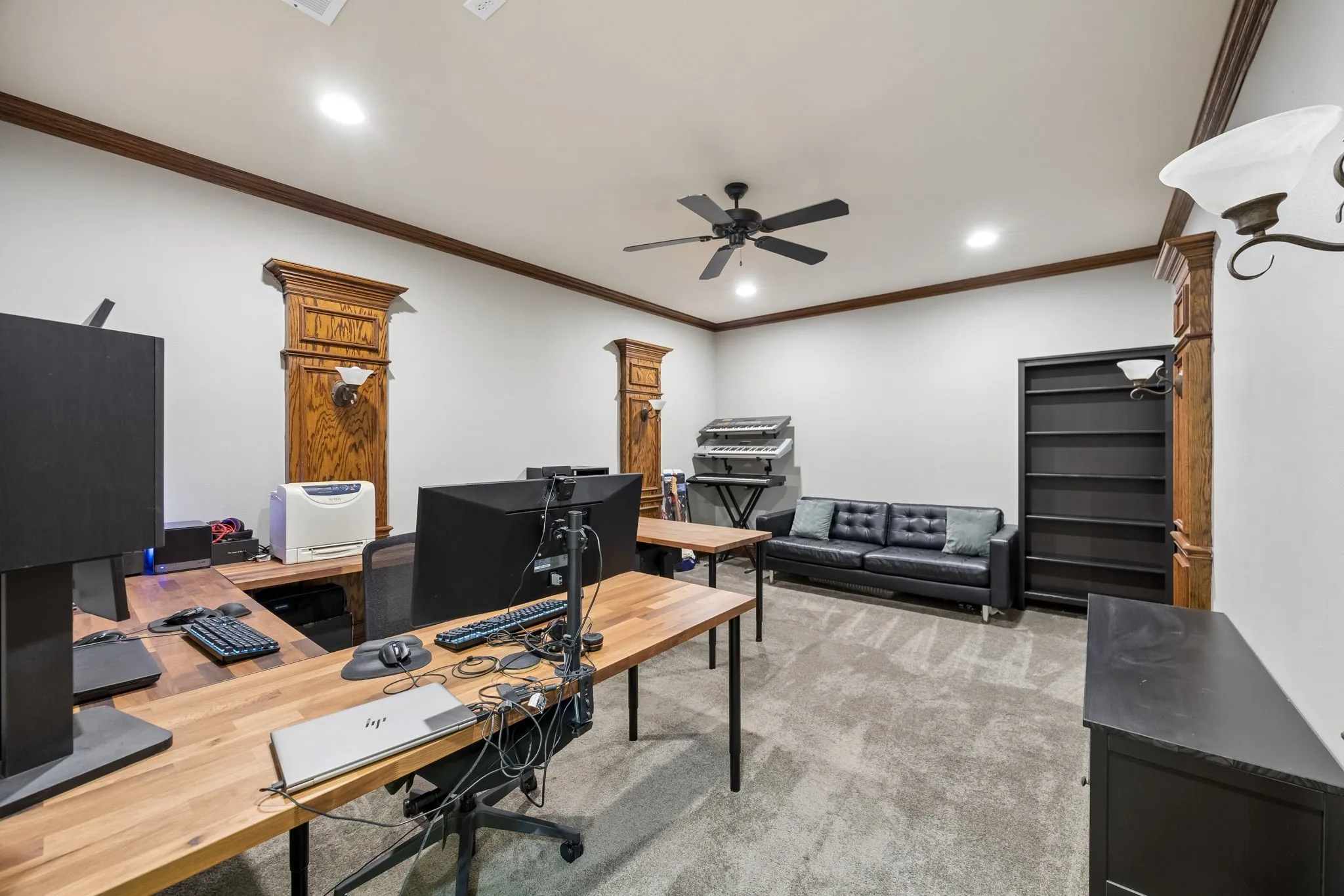 Media room with sconce lighting, upgraded carpet and pad