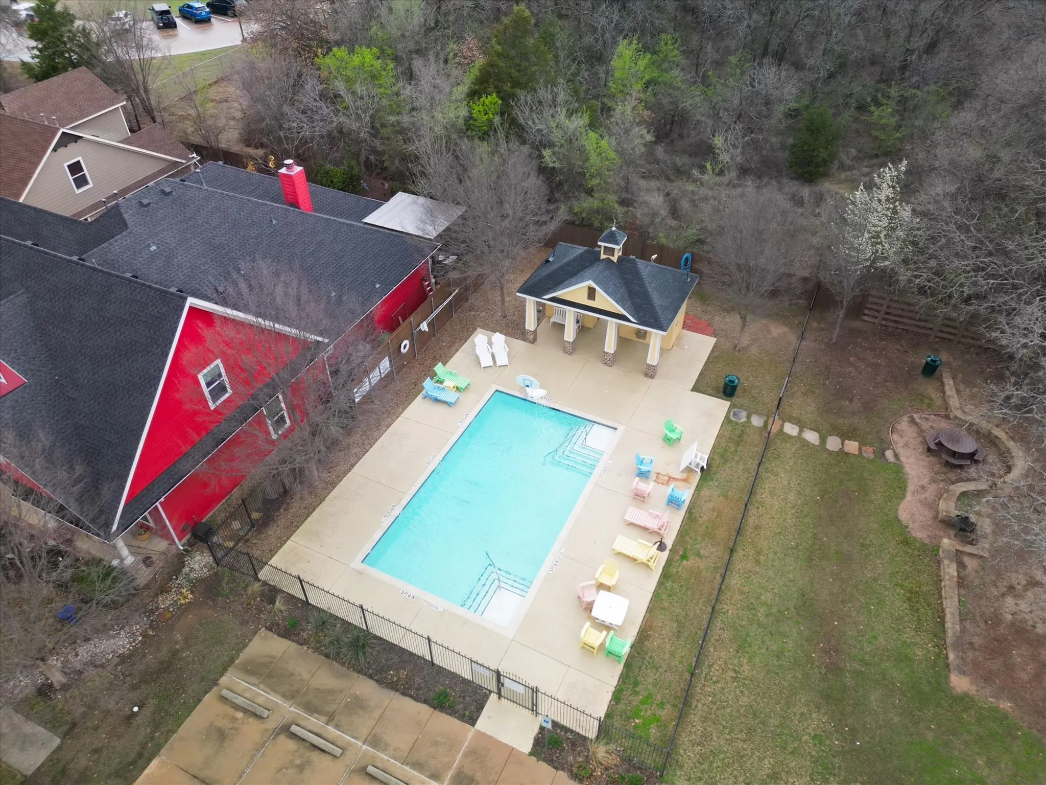 Rectangular swimming pool with integrated steps, surrounded by a paved deck