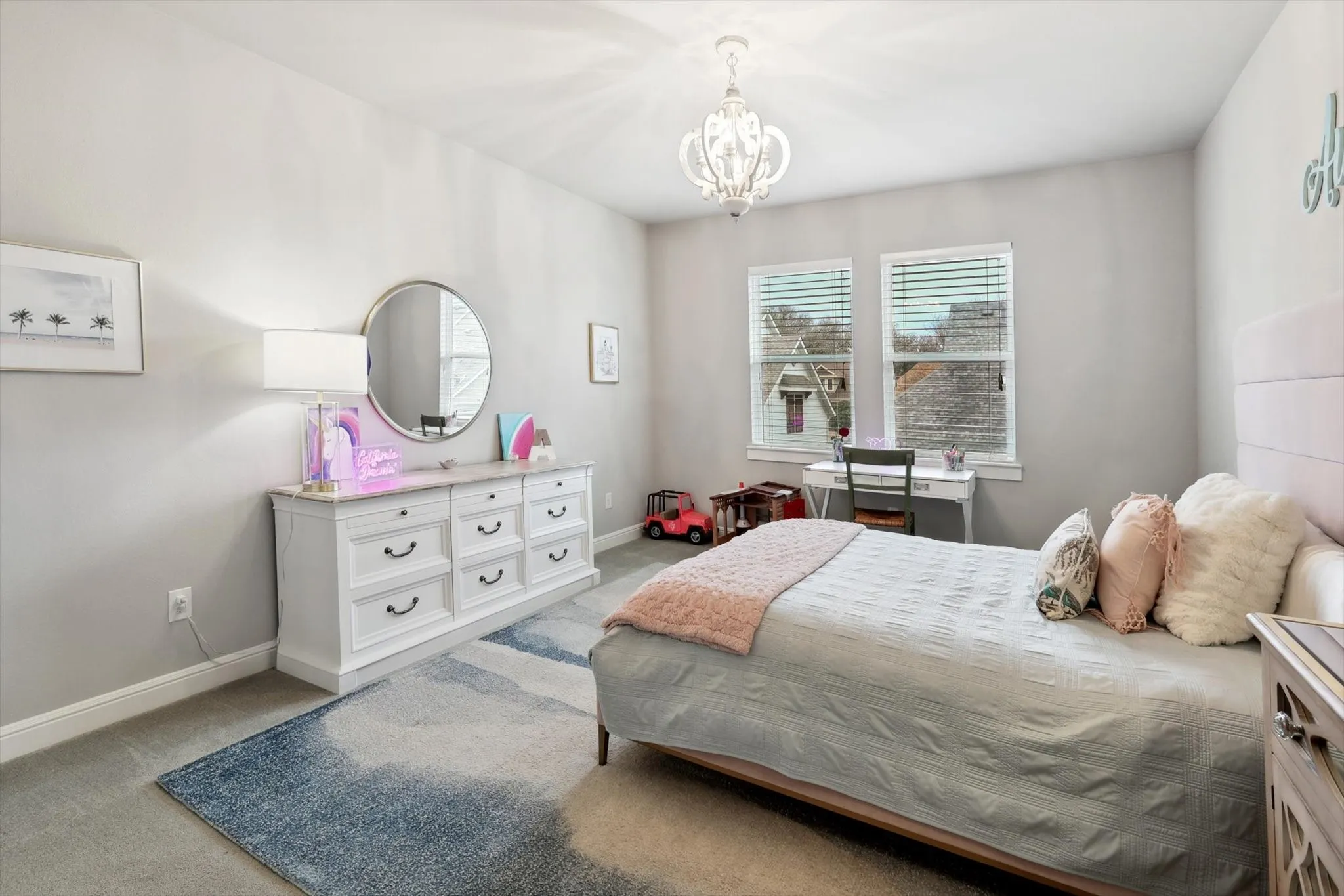 Recessed lighting and a decorative chandelier illuminate this room