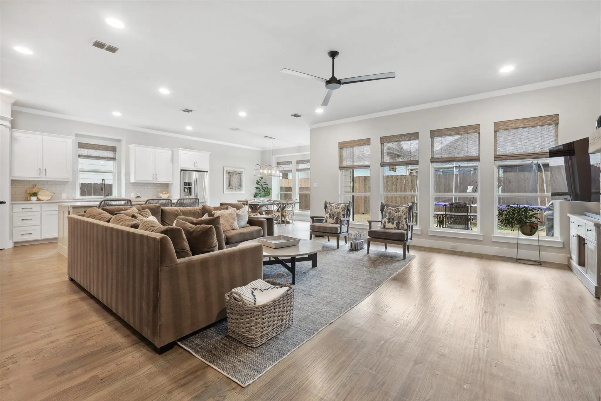 Open-concept living area with light wood-finish flooring, recessed lighting, and a ceiling​​‌​​​​‌​​‌‌​‌‌​​​‌‌​‌​‌​‌​​​‌​​ fan
