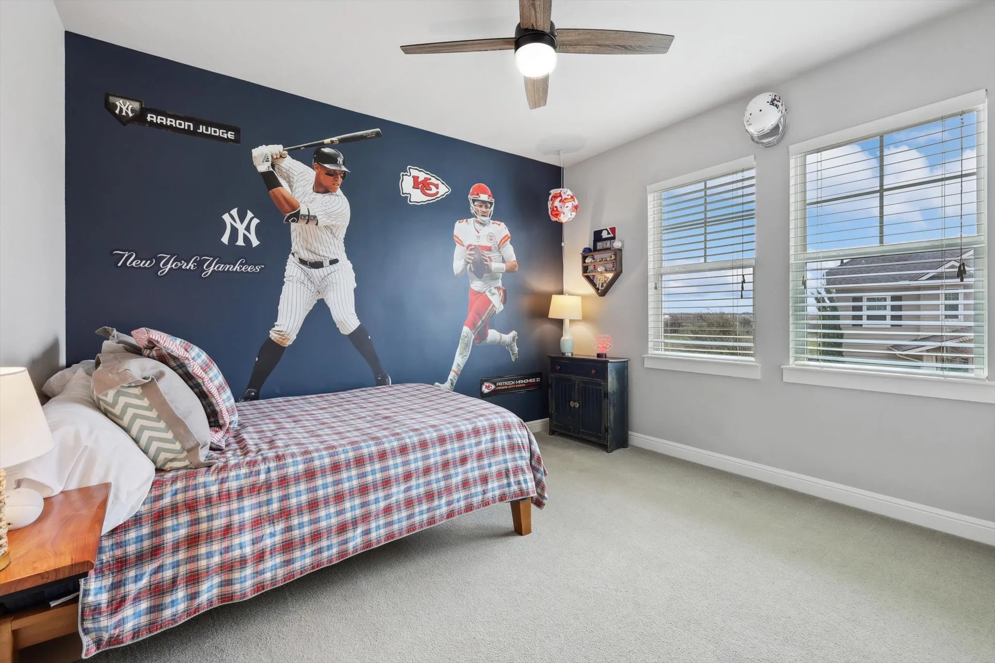 Recessed ceiling lighting, ceiling fan, carpeting, two large windows, and window blinds