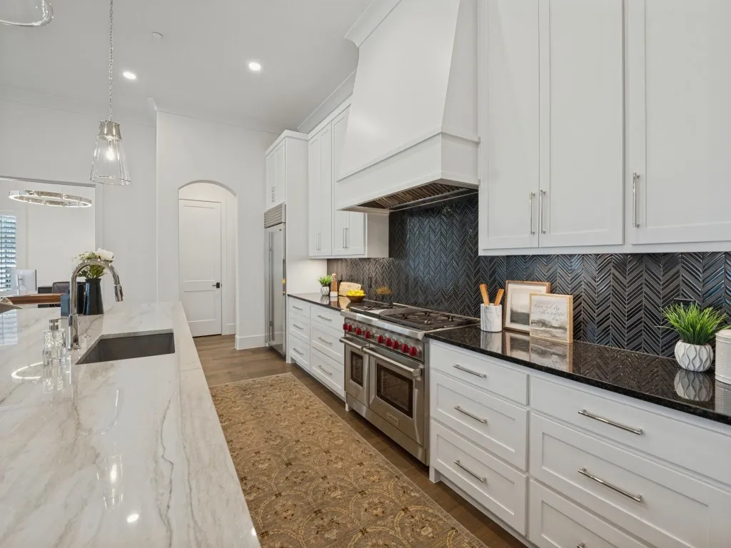 Tons of drawers and a beautiful herringbone backsplash to compliment the counter tops.
