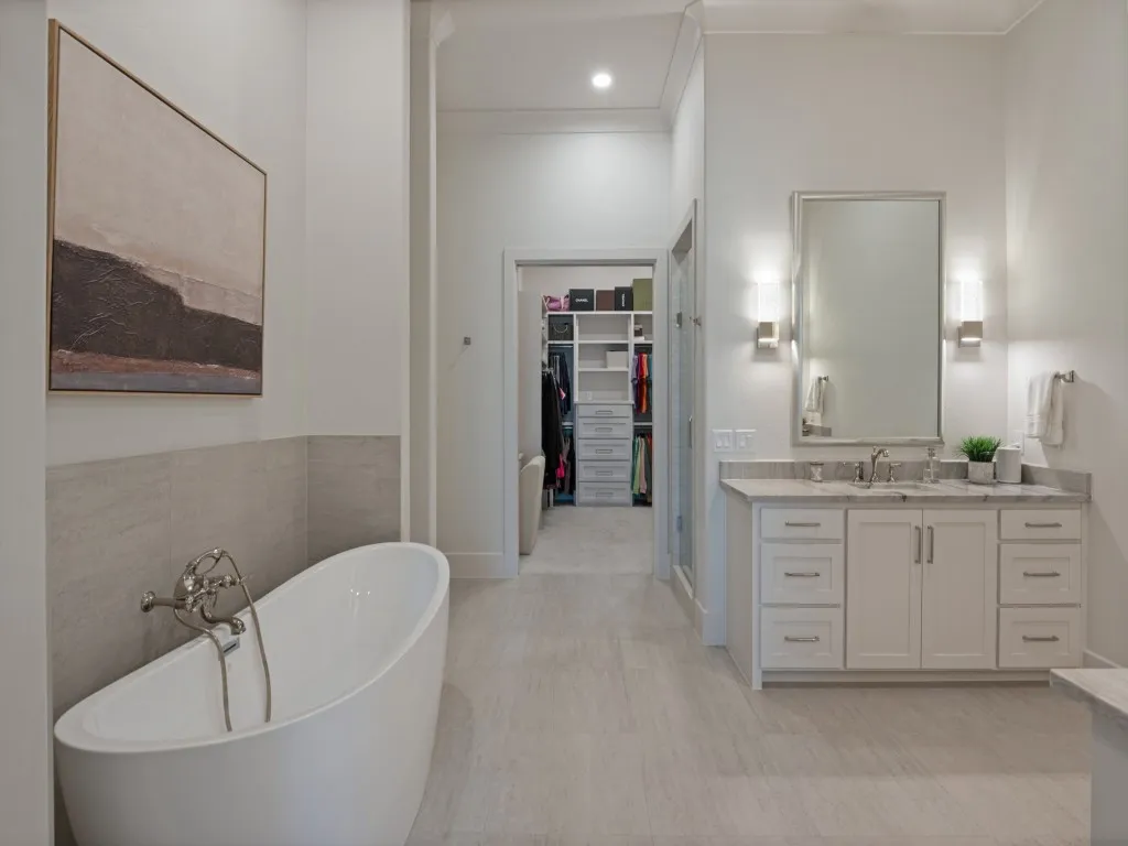 This photo shows how much room there is between the vanities and bath area that leads to the shower and closet.