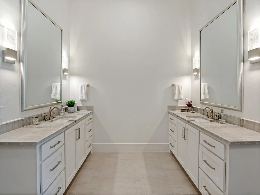Double vanities and large mirror with beautiful accent lighting.