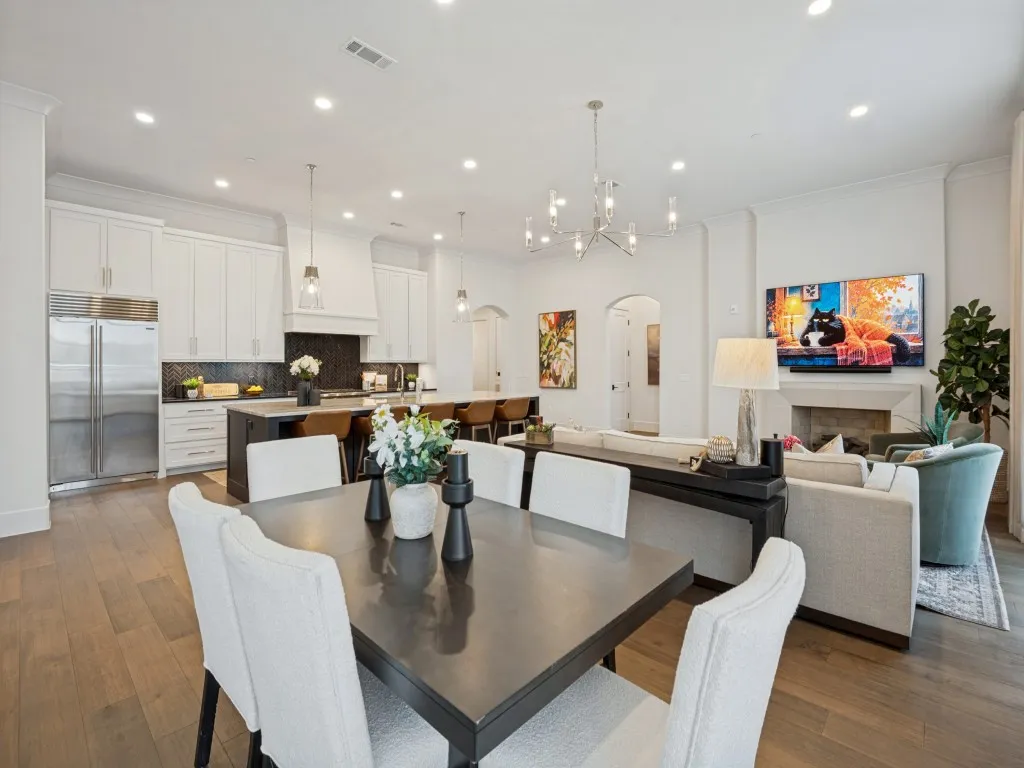 The dining area is open to the living room and kitchen with beautiful light fixtures and plenty of room for entertaining.