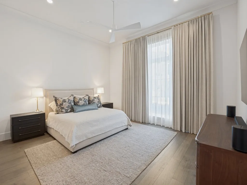 The primary bedroom is huge with plenty of room for furniture and beautiful custom drapery as well.