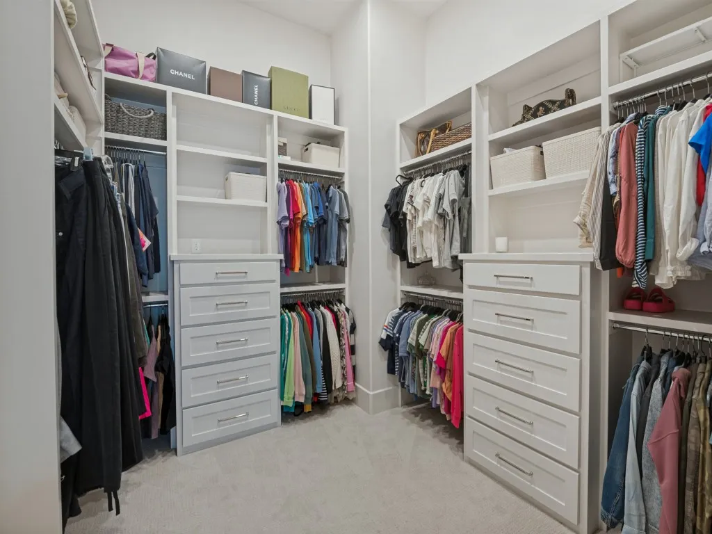 Two banks of drawers and lots of hanging space compliment the primary closet.