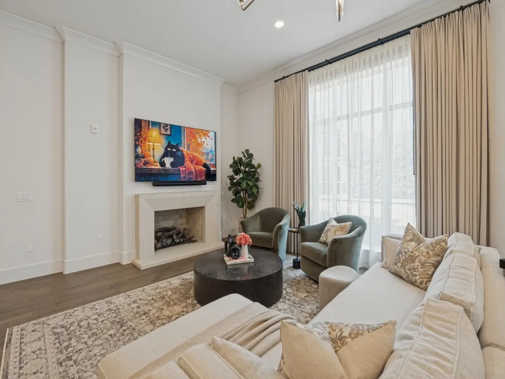 The beautiful cast stone fireplace is equipped with gas logs, and the TV mount above offers a perfect spot for viewing.
