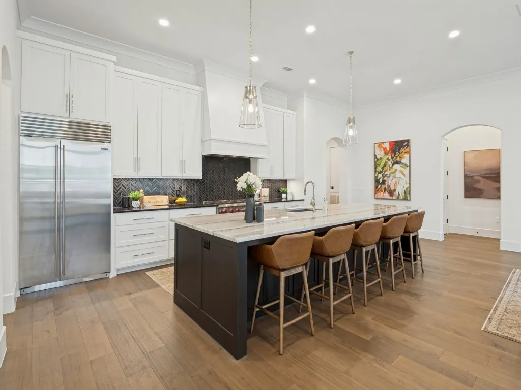 The kitchen features wonderful built in appliances including a 48" Wolf gas range with grill, and a large built in refrigerator/freezer. Lots of cabinets for storage and a walk in pantry.