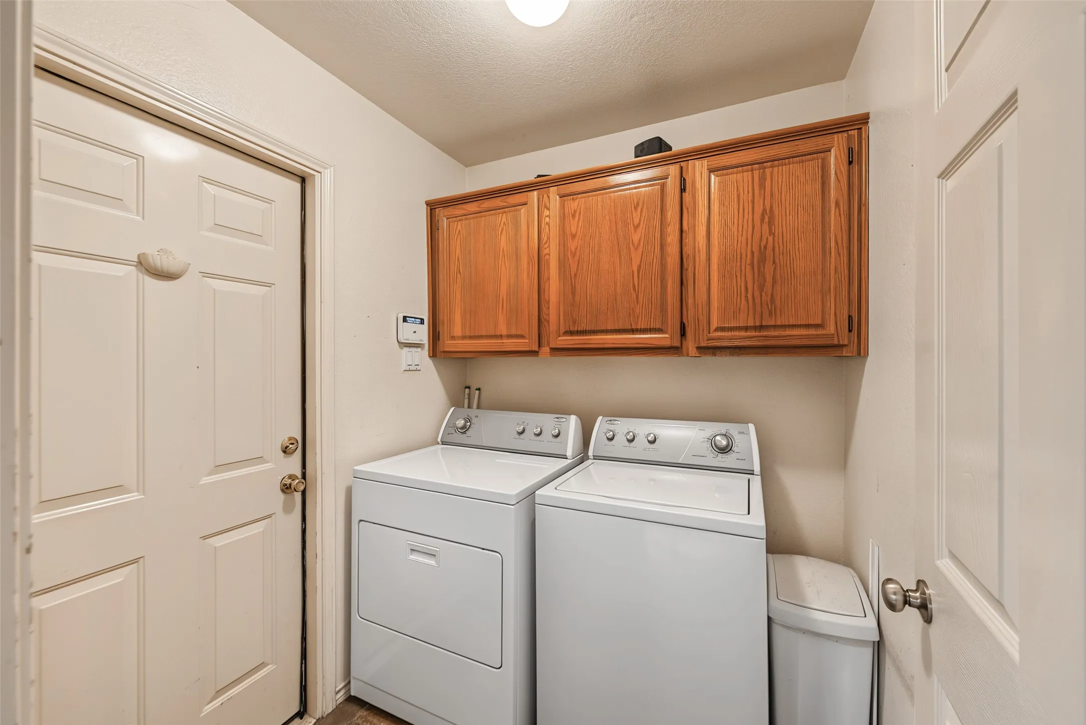 Wood-finish cabinetry providing overhead storage