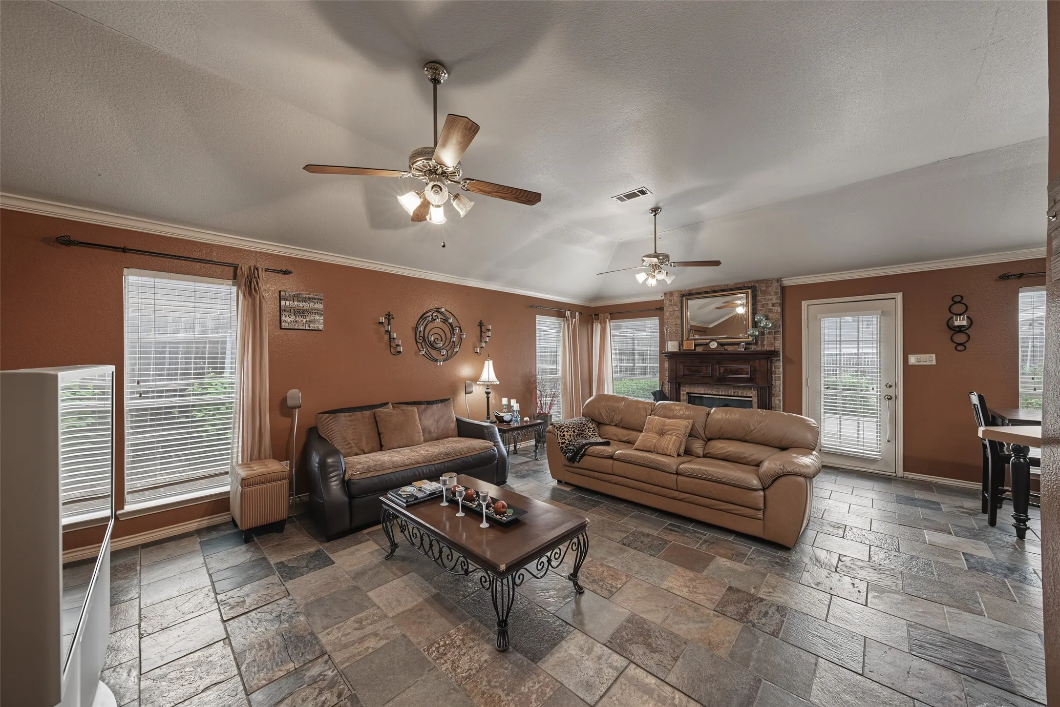 Multi-tone tile flooring, crown molding, and multiple ceiling fans