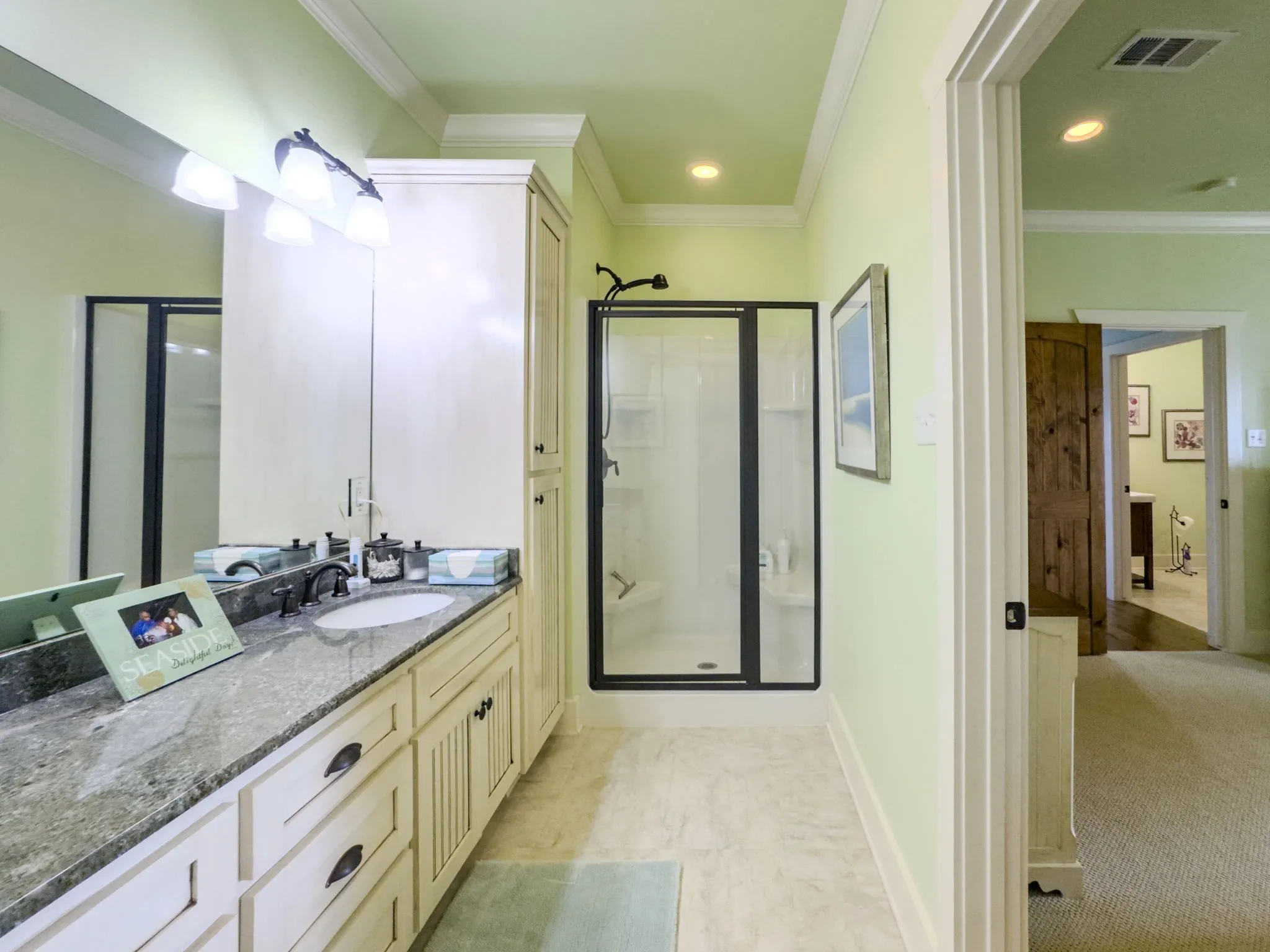 Double vanity with a dark countertop and integrated sink