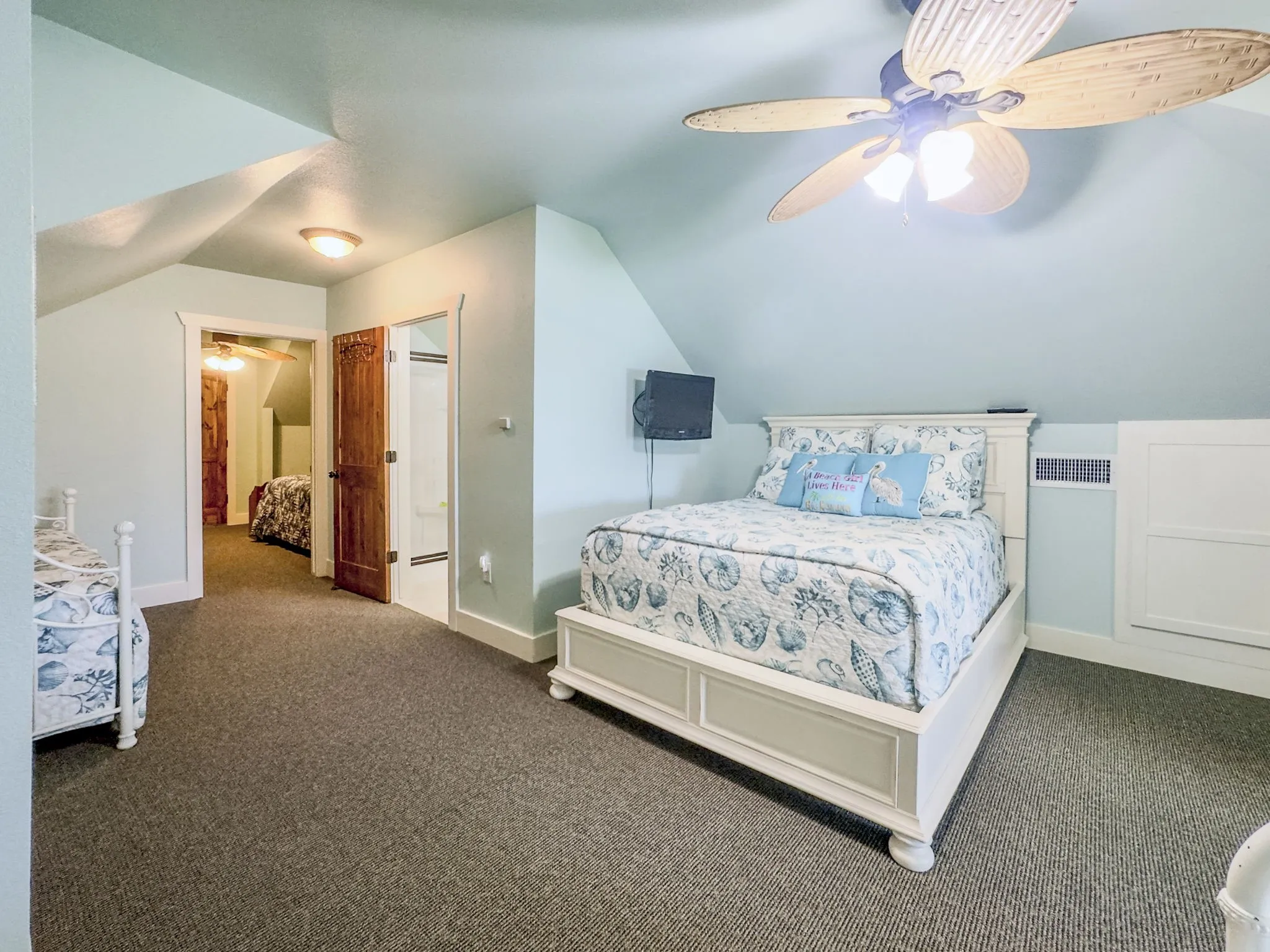 Carpeted flooring, vaulted ceiling, and paddle fan with integrated lighting