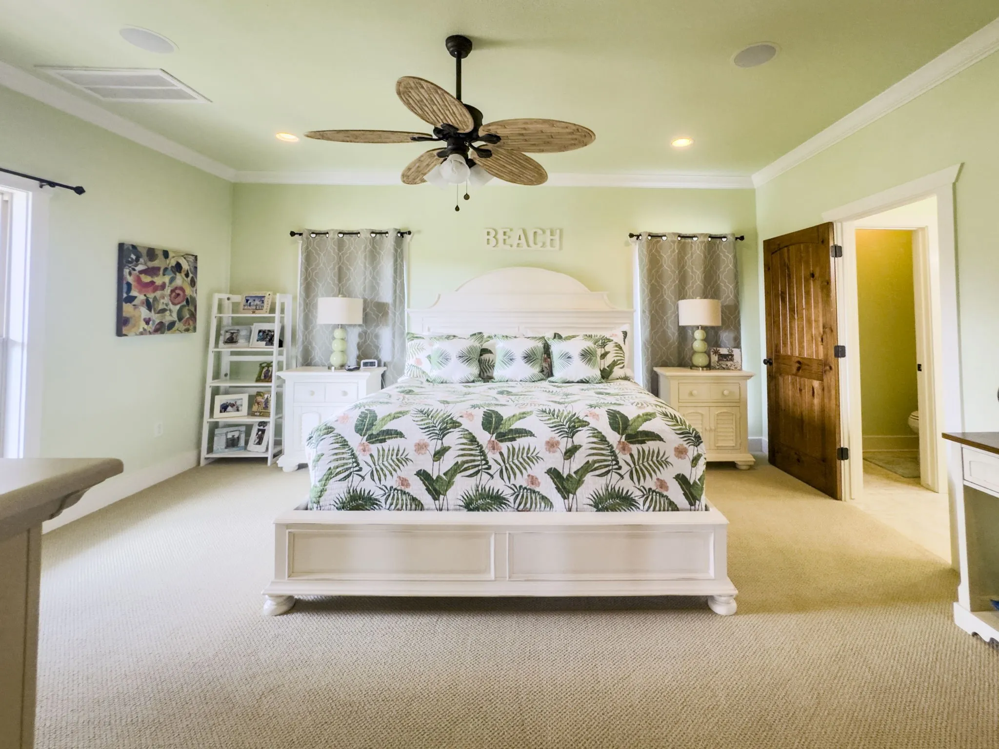 Textured carpeting throughout, crown molding detail, recessed lighting, ceiling fan with natural wood-finish blades, and a solid wood-panel door