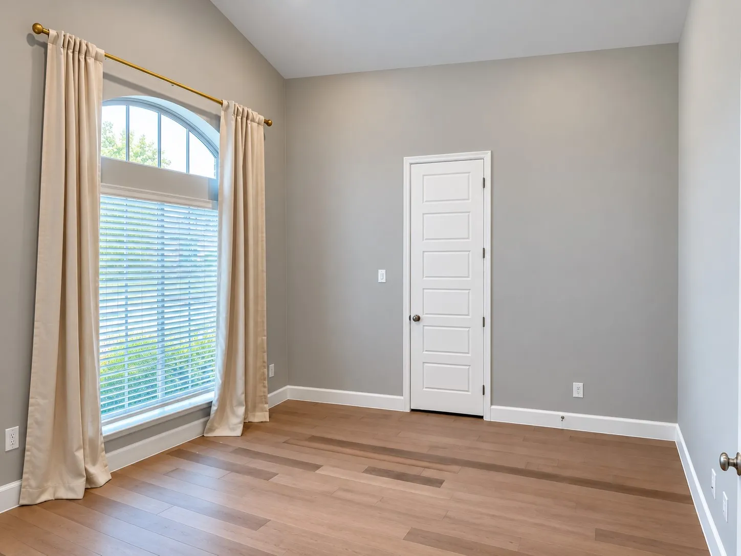  arched window, wood-finish flooring,