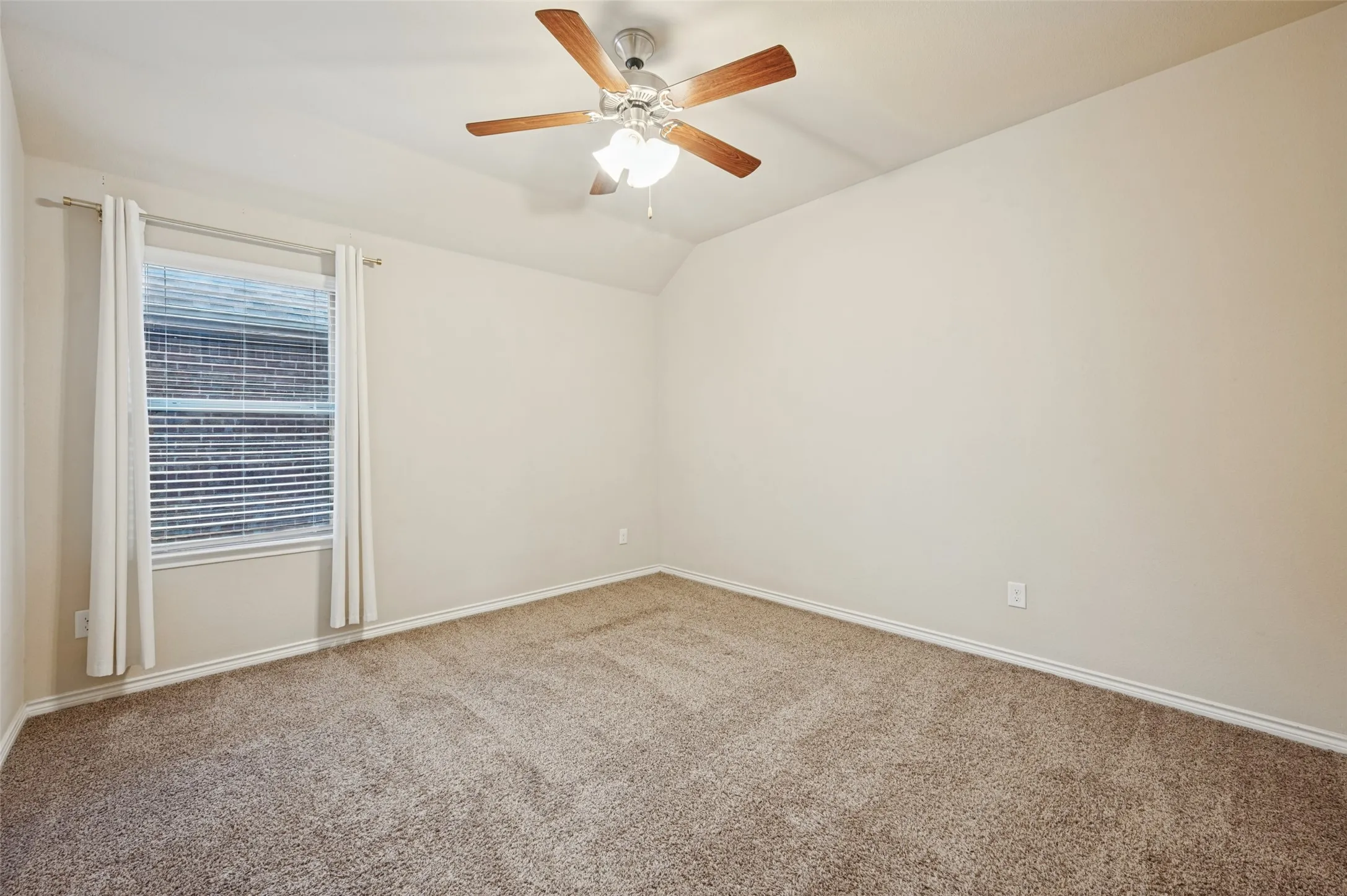 Recessed window with blinds, carpeted flooring, and a ceiling fan with integrated lighting