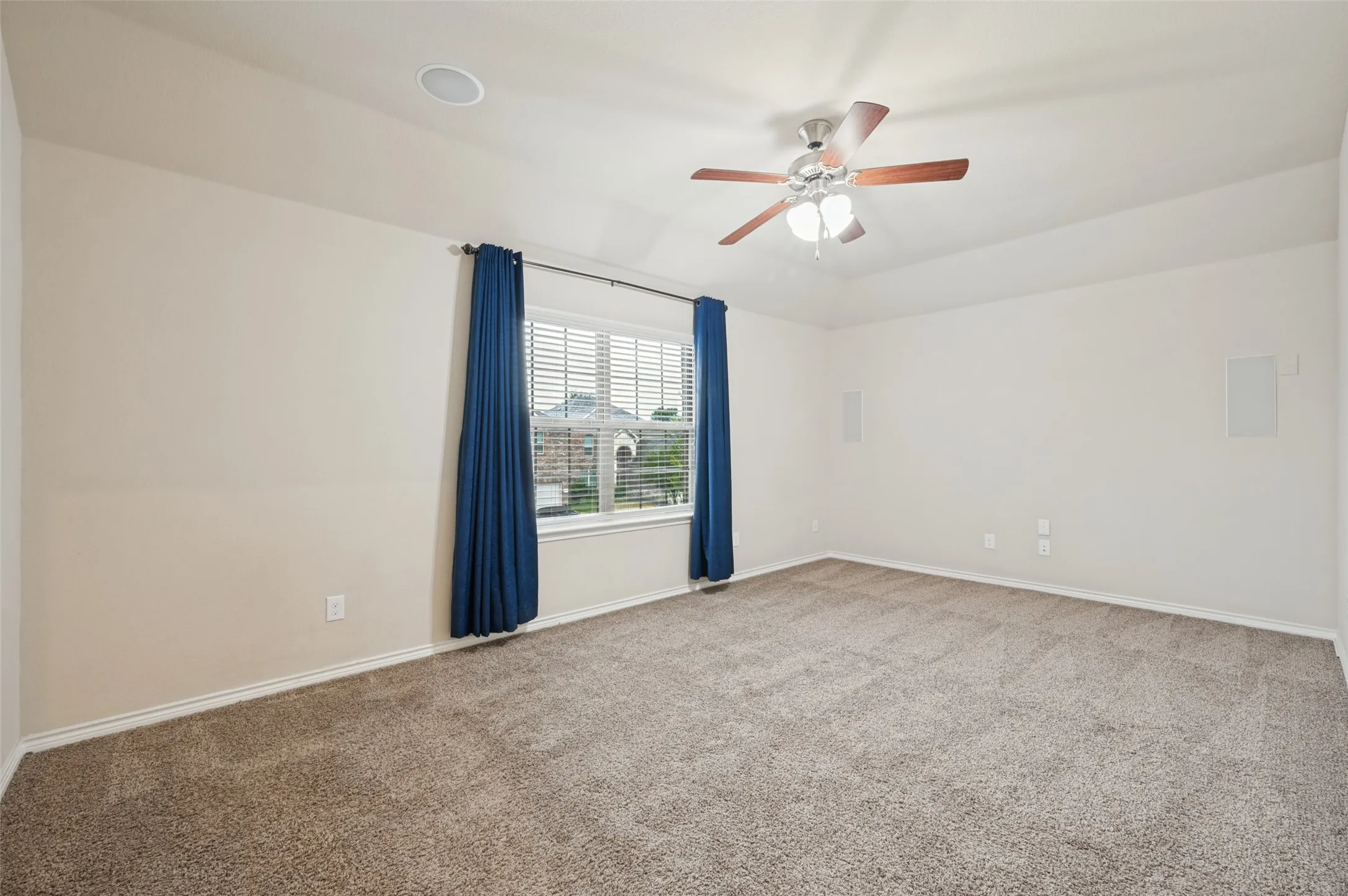 Tray ceiling with a ceiling fan, recessed lighting, and wall-mounted speakers