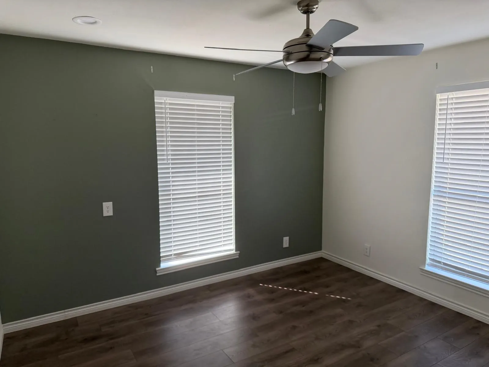 Recessed ceiling light, contemporary ceiling fan, wood-finish flooring, and window blinds