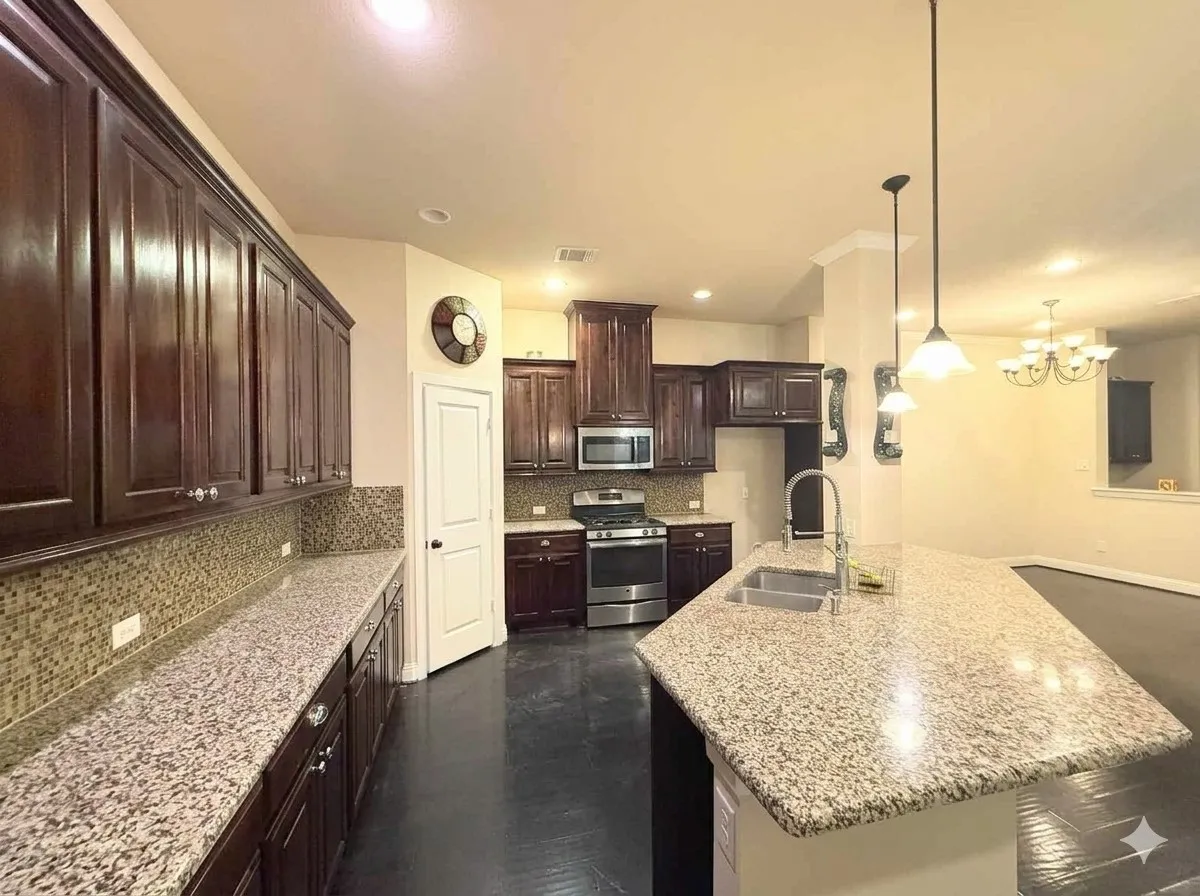 Kitchen featuring dark wood cabinetry, granite countertops, mosaic tile backsplash, and stainless steel appliances