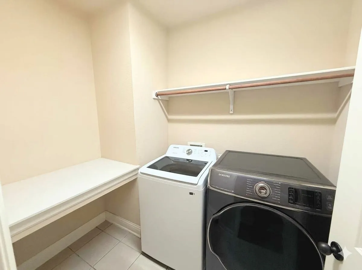 Built-in shelving, tile flooring, and a clothes rod for hanging