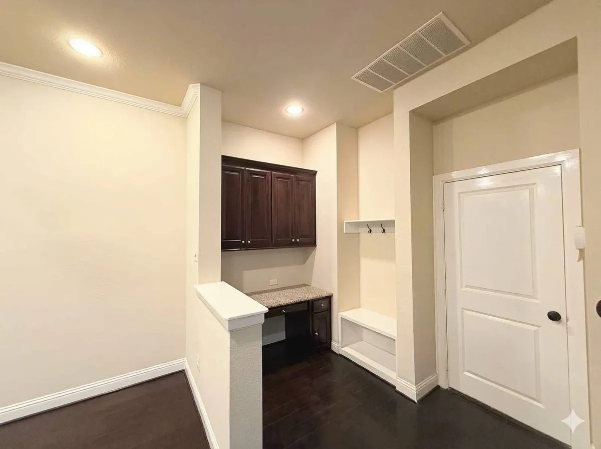 Built-in desk with dark wood cabinetry, light-toned countertop, recessed lighting, and wood-finish flooring