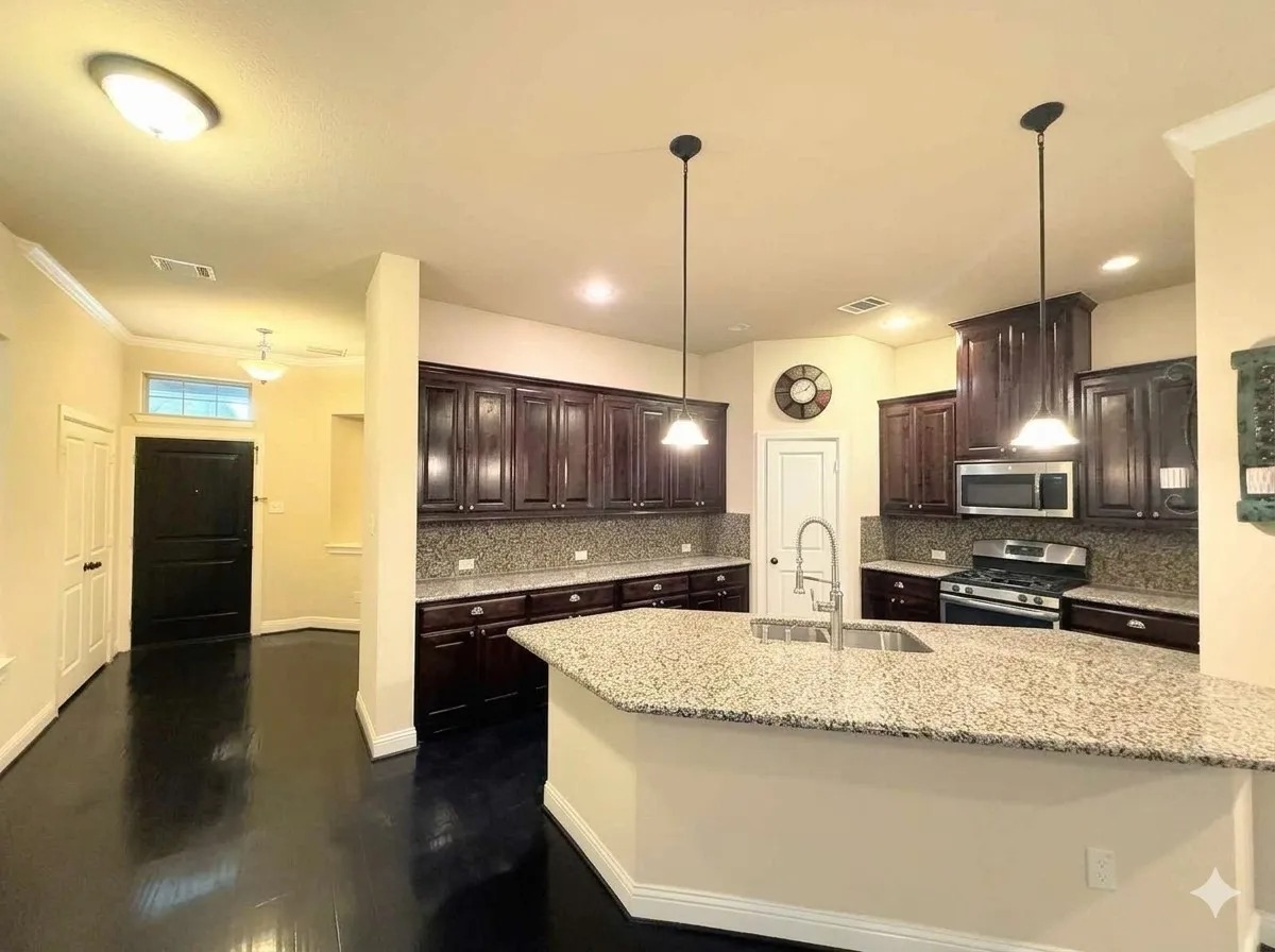 Kitchen featuring dark wood cabinetry, granite countertops, and stainless steel appliances