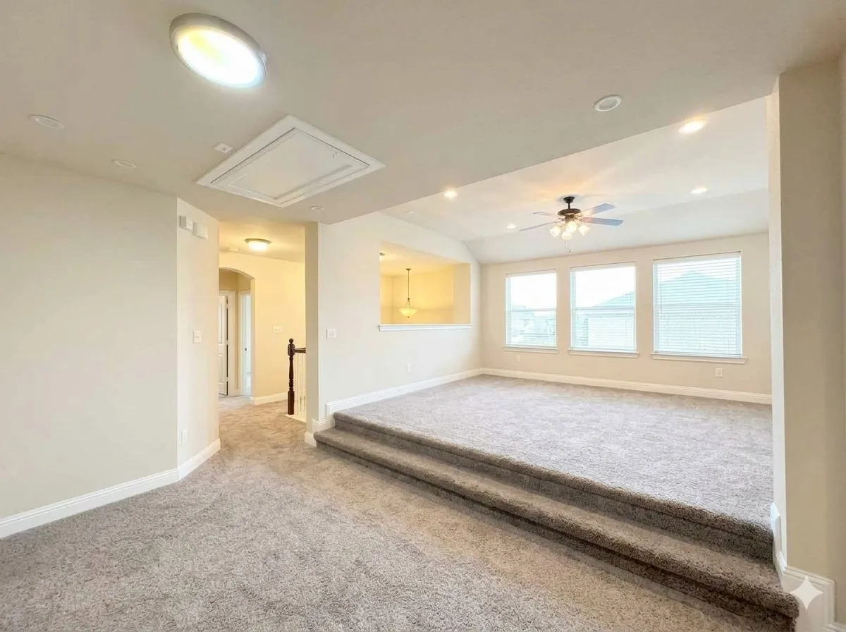 Tiered carpeted area with recessed lighting, ceiling fan, and multiple windows