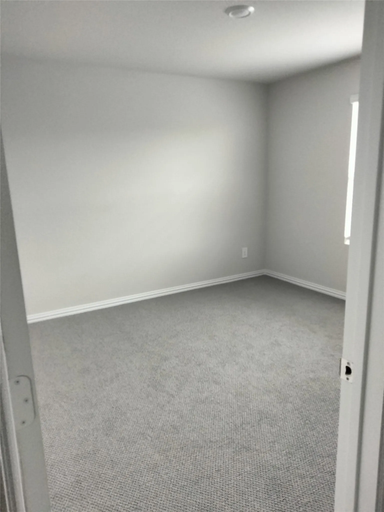 Wall-to-wall carpeting, window with natural light, recessed ceiling lighting
